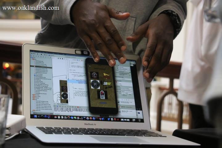 hands in fromnt of laptop open, in front of screen, in classroom