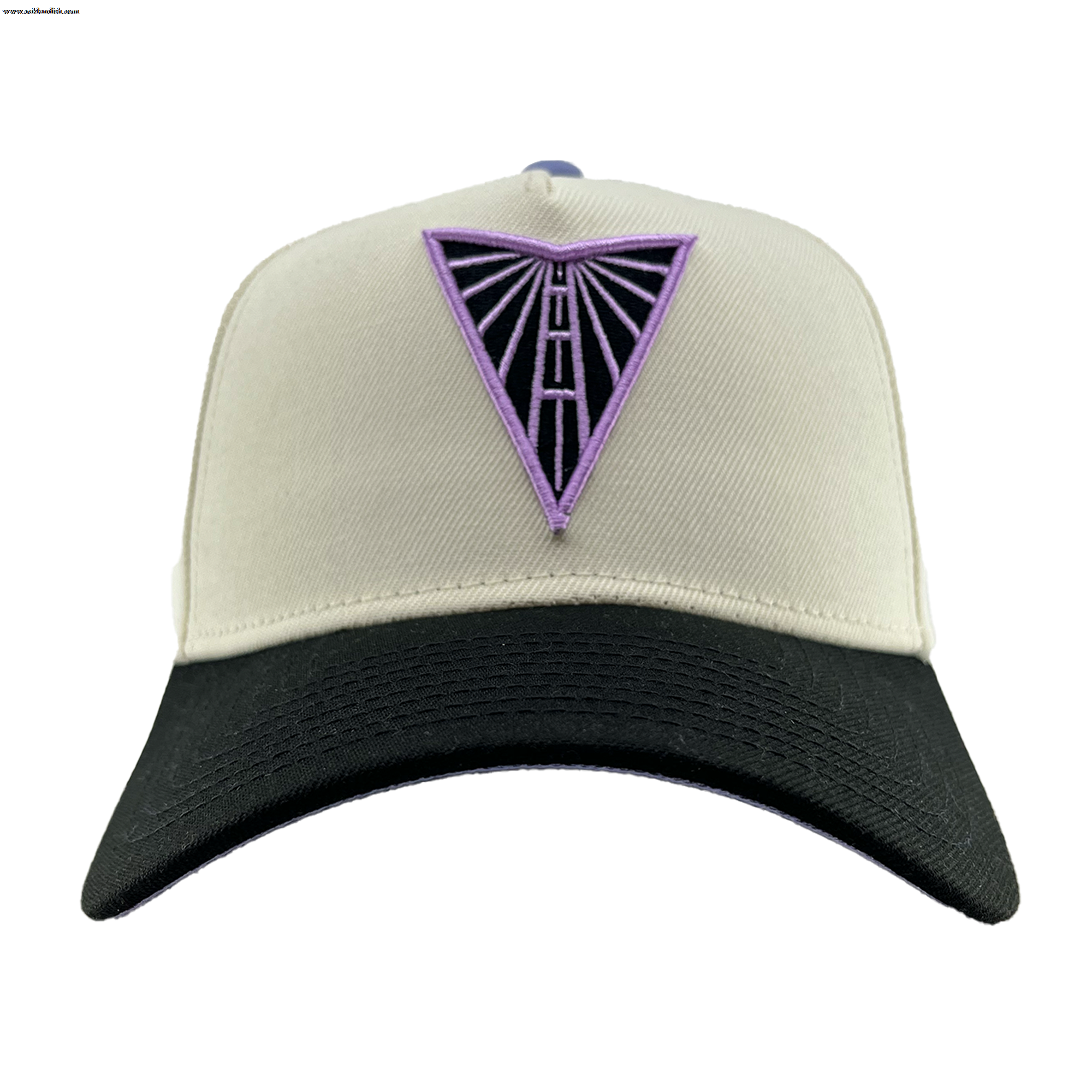 The GSV 9FORTY AF 2 Tone by GSV is a beige snapback baseball cap with a black curved brim. A purple triangle with black outline and geometric vertical lines is embroidered on the front. The adjustable hat is shown on a plain white background.