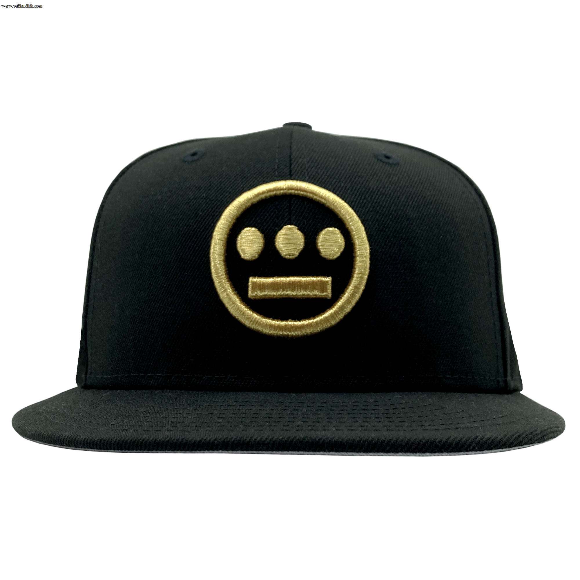 The New Era Hiero 59FIFTY Fitted Cap from Hieroglyphics features a black fabric with a flat brim, adorned with a gold embroidered circular logo reminiscent of hieroglyphics. The logo includes a straight line near the bottom and three smaller circles evenly spaced above it. This cap also has a white tag protruding on the right side.