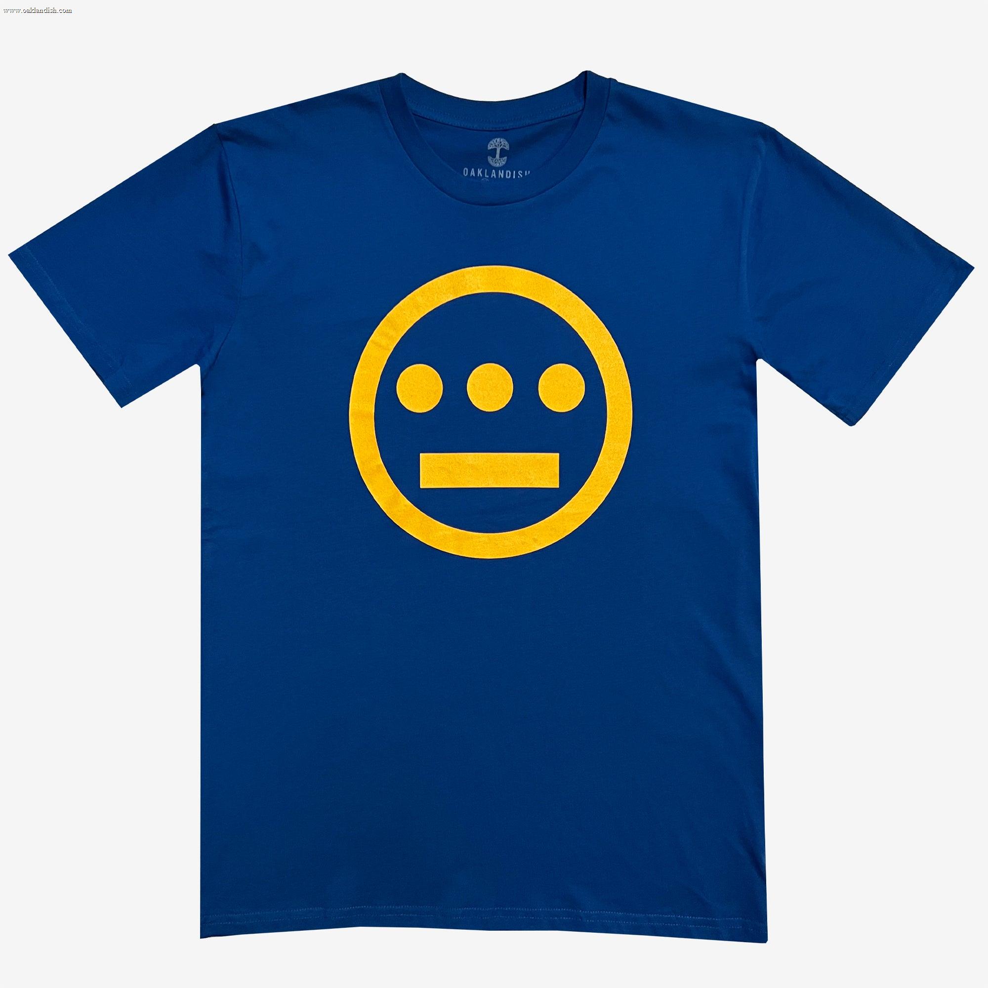 The Hiero Classic Logo Tee by Hieroglyphics features a classic fit blue t-shirt with a bright yellow circular logo on the chest. The logo consists of a circle with three dots arranged horizontally above a straight horizontal line, resembling hieroglyphics. The shirt has a crew neck and short sleeves.