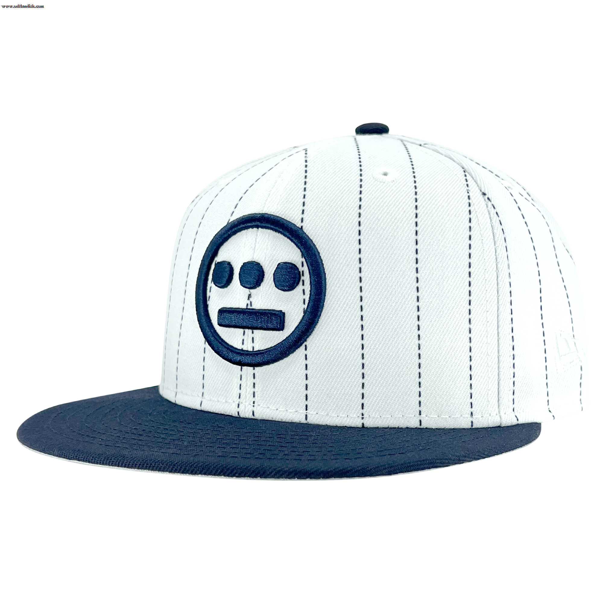The New Era Hiero Pinstripe 59FIFTY Fitted Cap by Other features a white crown with thin vertical black pinstripes, a navy blue brim, and a bold navy blue embroidered Hieroglyphics face—three dots over a line inside a circle—on the front panel. This fitted cap channels classic hip hop headwear vibes, making it a standout addition to your collection and evoking the iconic style of New Era’s 59FIFTY line. The background is plain white.