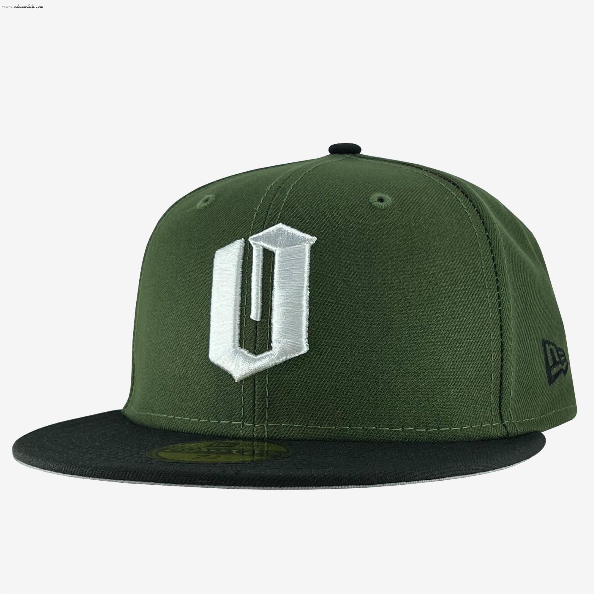 A green New Era Official 59FIFTY Fitted Cap from the brand Other, this fitted hat features a black flat brim and a prominent white embroidered “U” on the front. The signature New Era logo is stitched in black on the left side, while ventilation eyelets on the top ensure breathability.