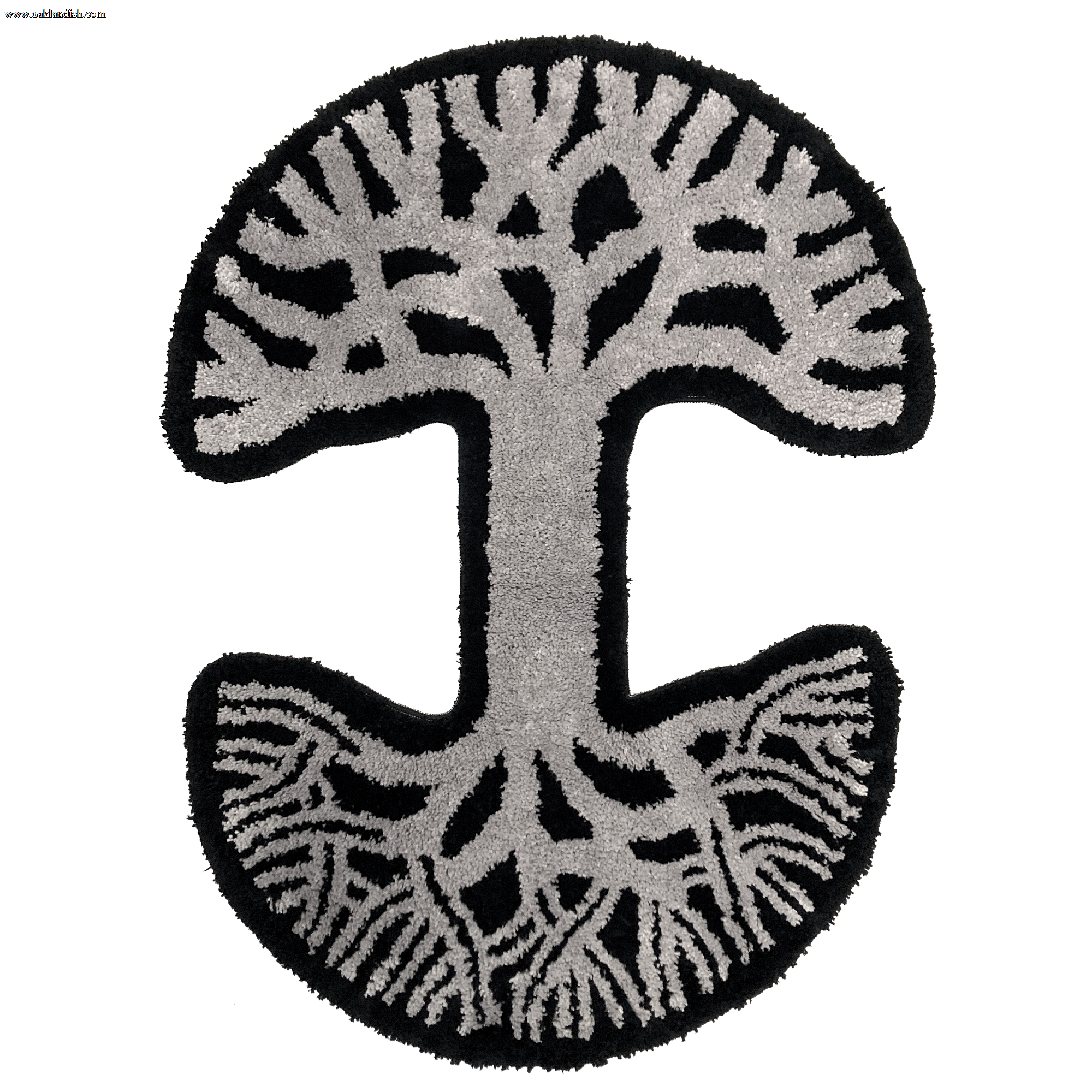 The Oaklandish Logo Rug by Oaklandish features a circular design inspired by the abstract tree logo. The rug has a striking contrast with a black background and detailed gray patterns depicting intertwined branches forming a broad canopy at the top and an intricate network of roots at the bottom.