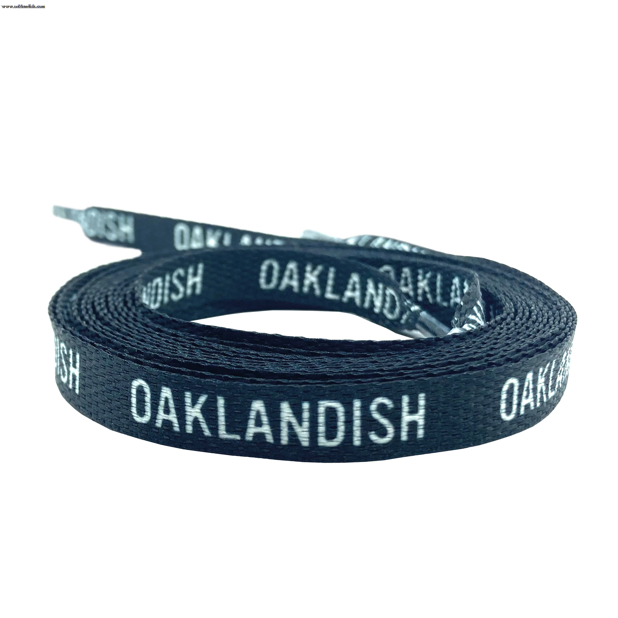 The Wordmark Shoelaces by Oaklandish, made from 100% polyester and featuring a woven texture, are displayed coiled against a white background. These flat black shoelaces have the text "OAKLANDISH" repeatedly printed in white and include standard tipped ends.