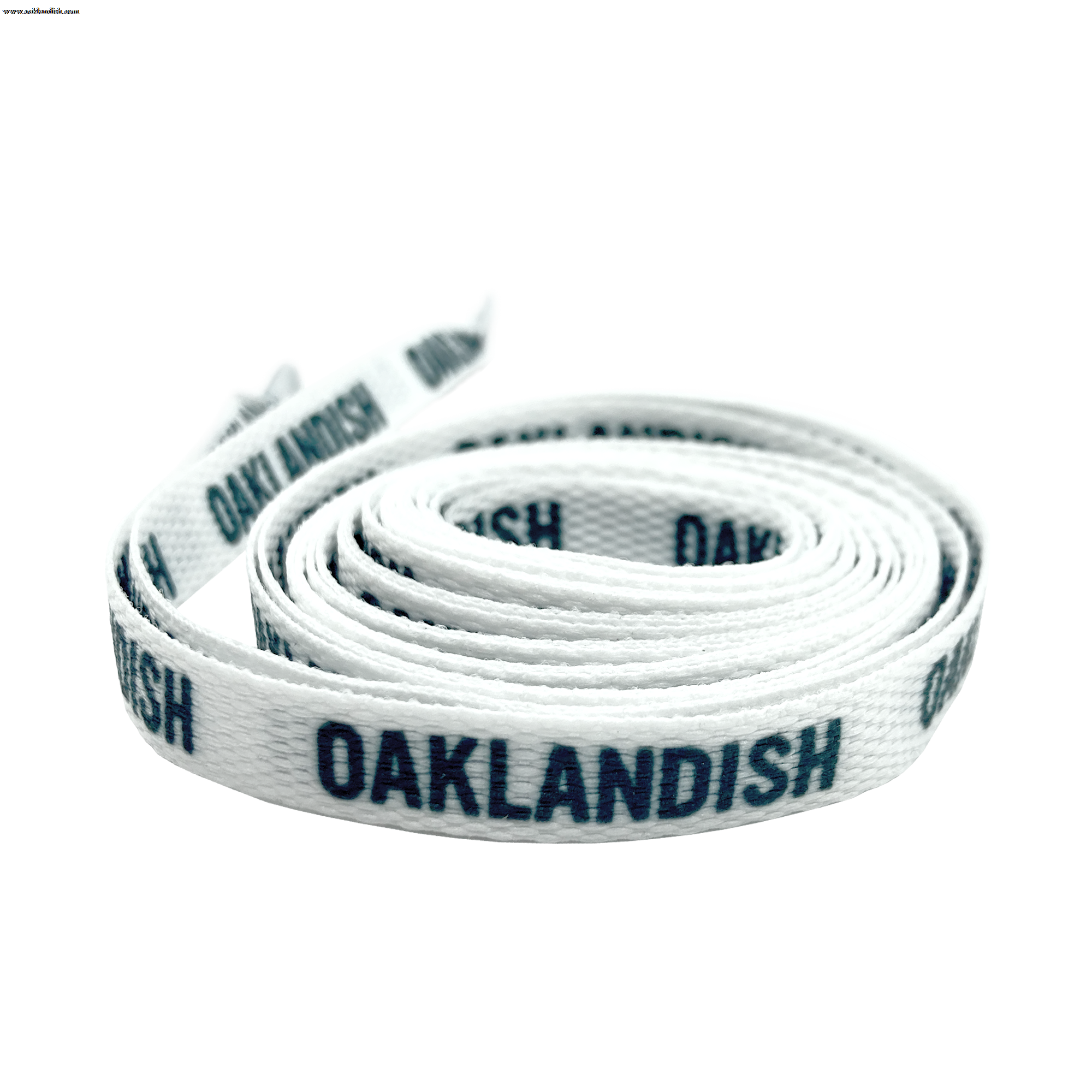 The Wordmark Shoelaces by Oaklandish are coiled white polyester laces with the word "OAKLANDISH" printed in black, repeated along their length. The flat shoelace is neatly wound and lies flat with one end slightly elevated, showing a visible tip.