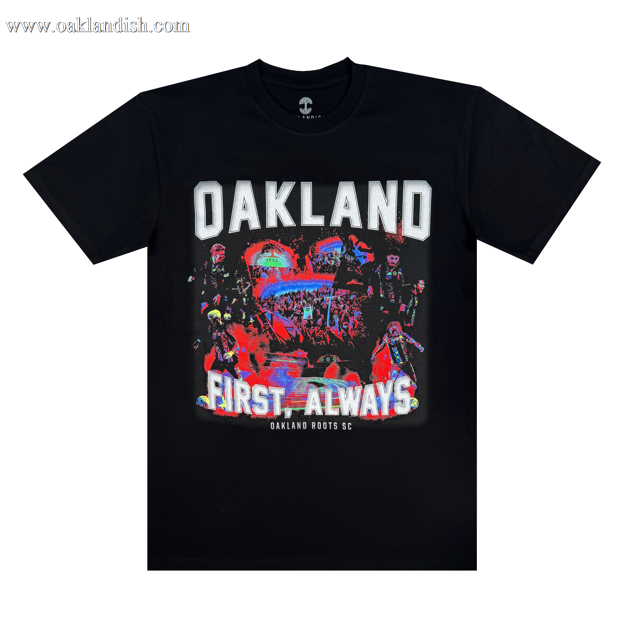 The OFA Tour Tee by Oakland Roots SC is a black T-shirt featuring "OAKLAND" in bold white letters, colorful abstract art of people and urban elements, and the phrases "FIRST. ALWAYS" and "Oakland Roots SC," highlighting the sports club's dedication to social good.