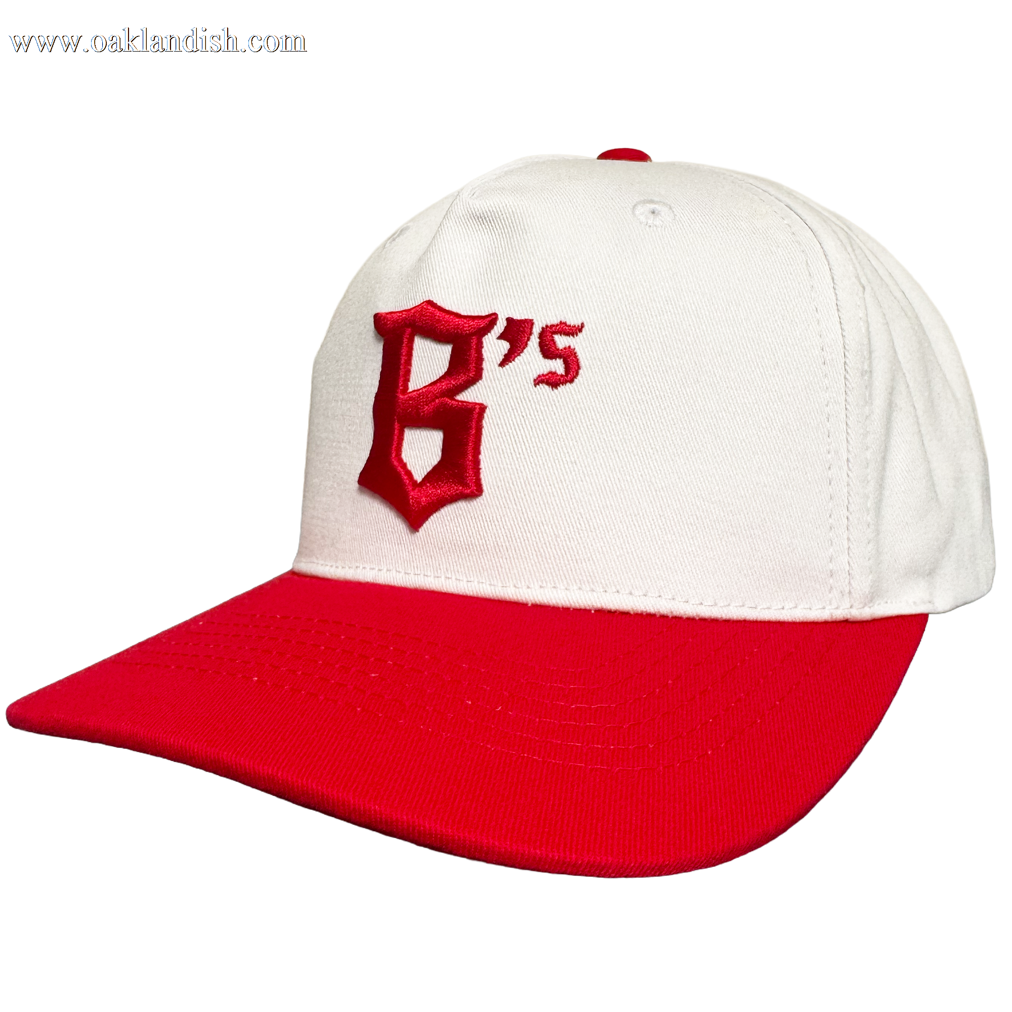 The Oakland Ballers 5 Panel Cap by Oakland Ballers features a white snapback design, red brim, and bold red embroidered "B's" on the front—perfect for any fan. The cap is displayed angled against a plain white background.