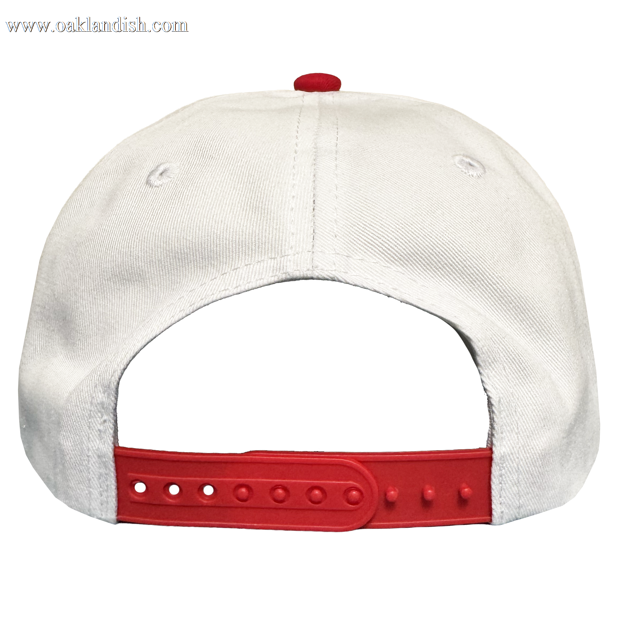 The Oakland Ballers 5 Panel Cap, by Oakland Ballers, is a white snapback viewed from the back with a red adjustable strap, red top button, two small ventilation holes, and set against a plain white background.