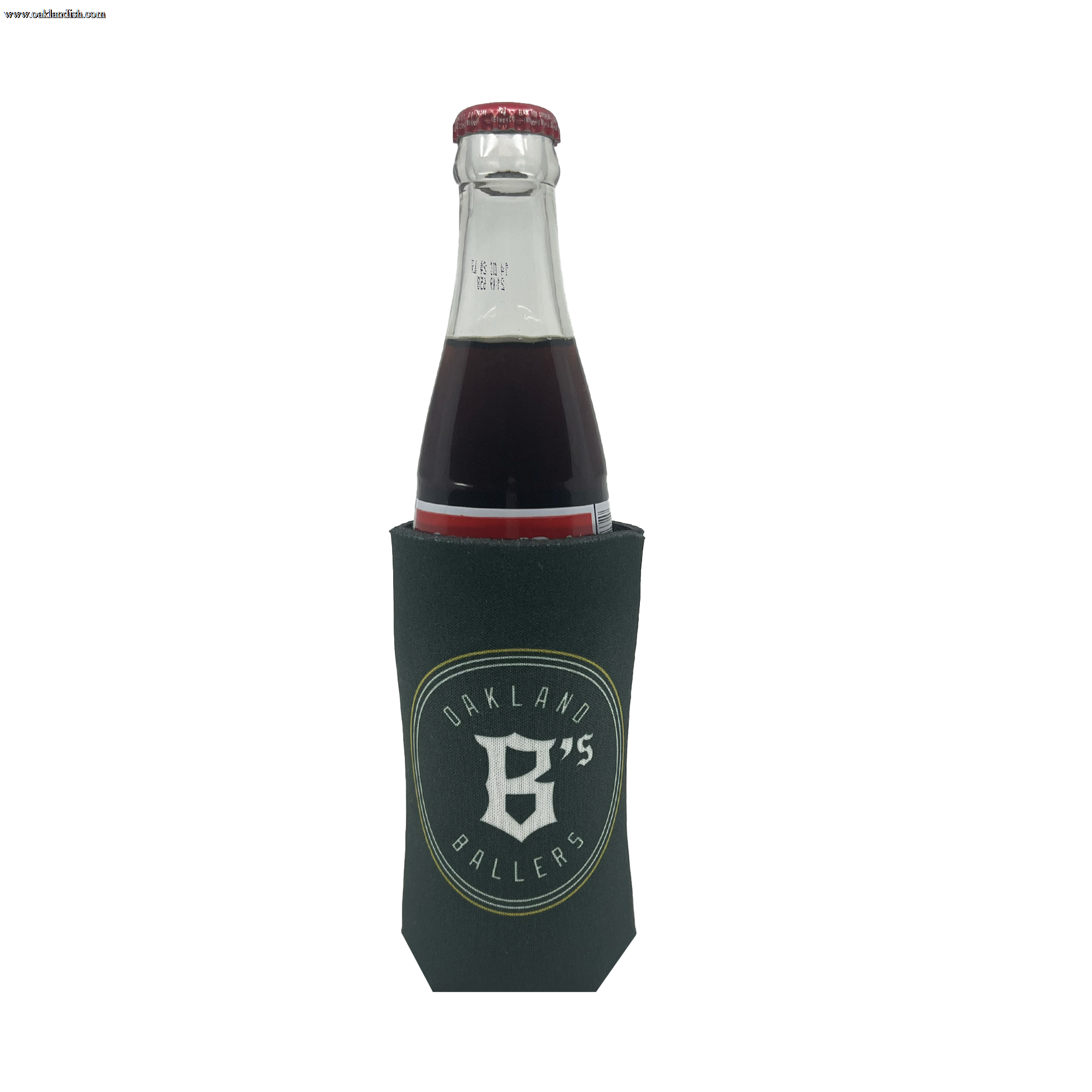 A beverage bottle with a dark-colored drink is placed inside the Oakland Ballers 16oz Can Cooler, which is green and features the bold logo and text: "OAKLAND 95 BALLERS," representing the professional baseball team from the Pioneer League, with a prominent 'B' and '95' at its center. The beverage looks dark red or brown.