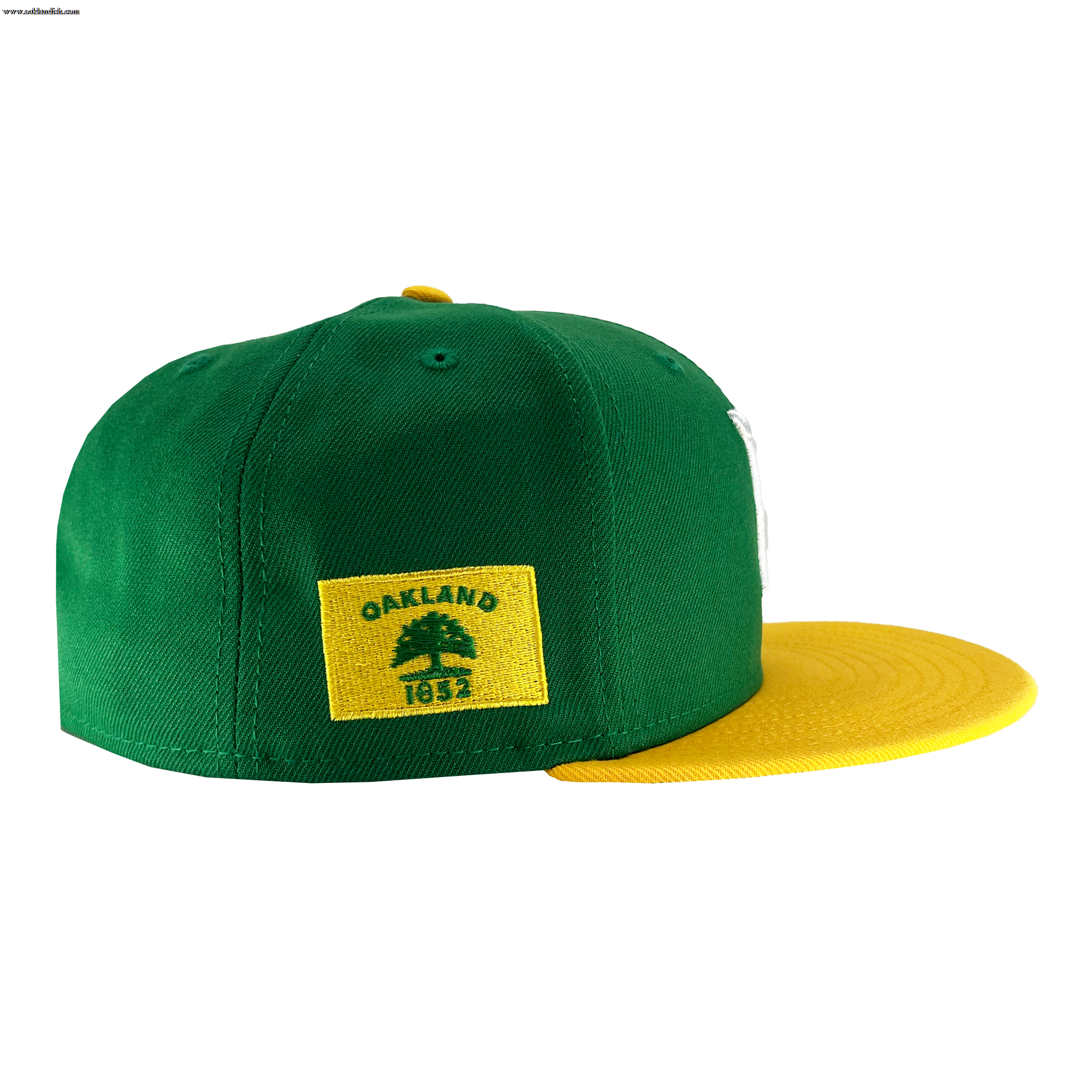 A green and yellow New Era Oakland Ballers 59Fifty Cap by Oakland Ballers is depicted. The back panel is green with a yellow rectangular patch that displays a green tree and the text "OAKLAND 1852," capturing the essence of Oakland sports team pride. The brim of the cap is yellow. The hat is presented on a white background, highlighting its side and back views.