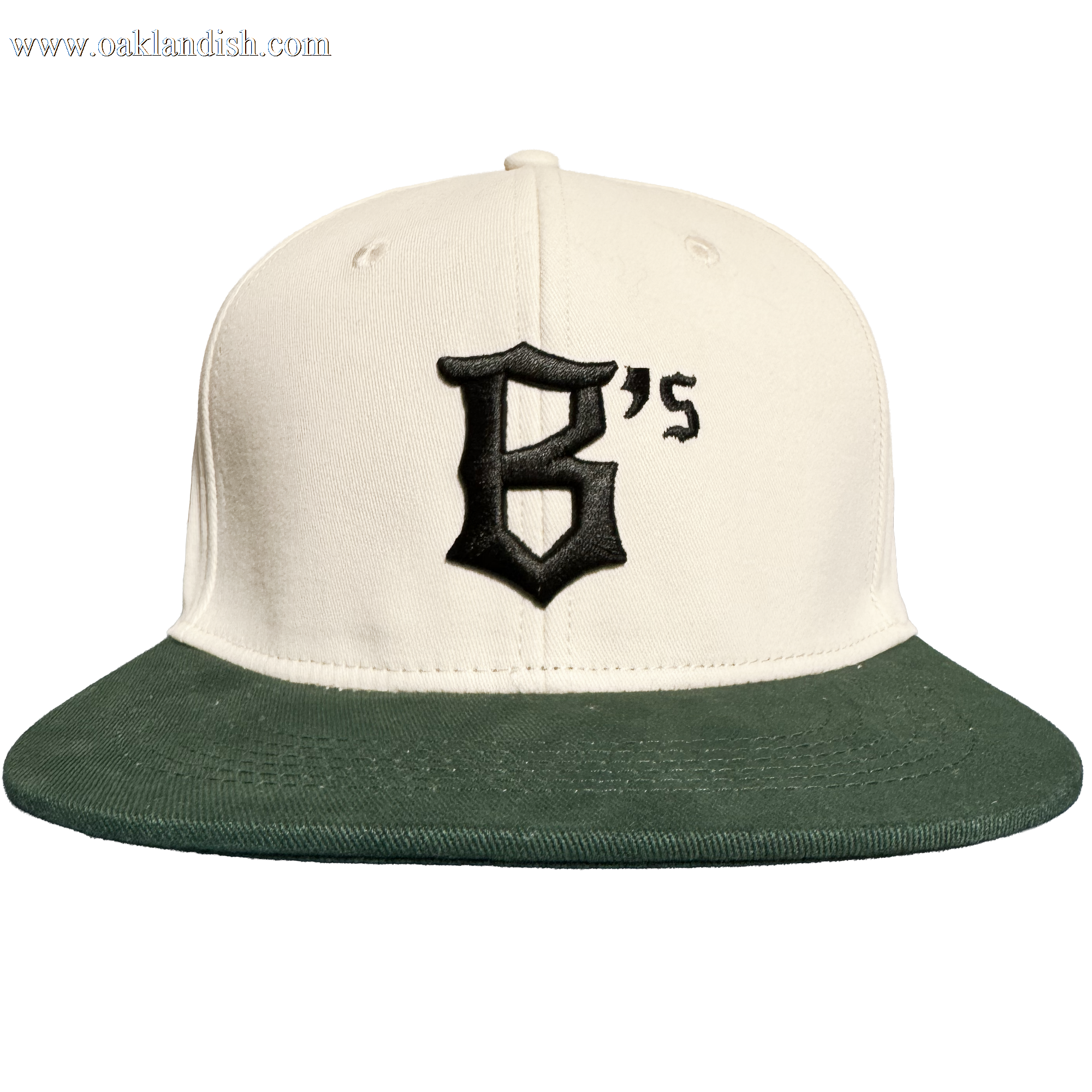 Introducing the Oakland Peloteros Hat by Oakland Ballers—a cream-colored baseball cap with a dark green brim, inspired by the Oakland Ballers from the Pioneer League. The front displays a bold black "B's" in gothic font, capturing the vibrant spirit of Oakland’s newest baseball team. Set against a plain white background.
