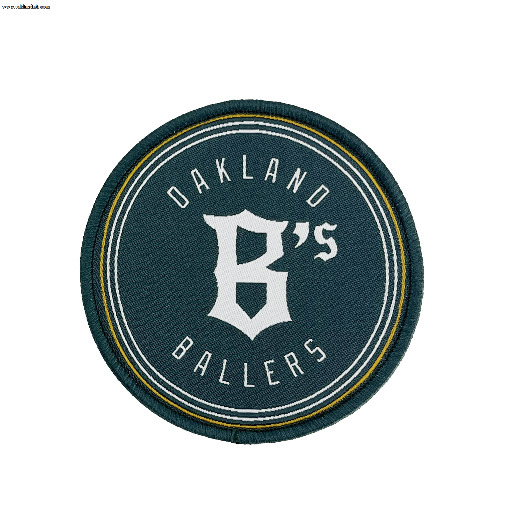 The Oakland Ballers Logo Patch from the Oakland Ballers features a circular design with a dark green background. The words "Oakland Ballers" are arched along the top and bottom edges, while a large, stylized white "B's" occupies the center. Representing the professional baseball team in the Pioneer League, this patch is bordered by thin white and yellow rings.