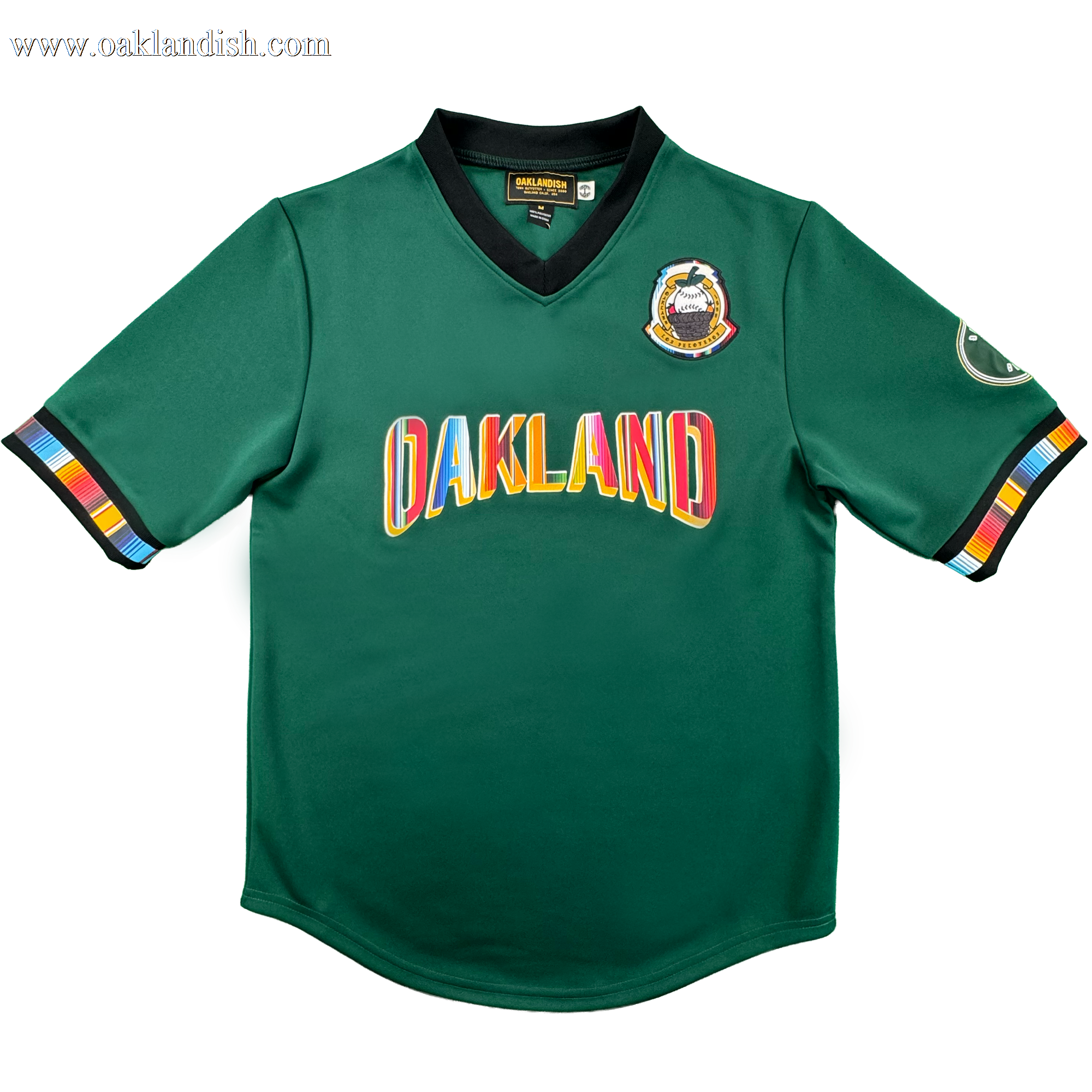 Introducing the Peloteros Jersey by Oakland Ballers: a vibrant green sports jersey inspired by the Oakland Ballers baseball team, featuring "OAKLAND" in multicolored letters across the front, a colorful badge on the left chest, an oval patch on the right sleeve, and black-trimmed sleeves and collar accented with multicolored stripes—a lively tribute to Pioneer League style.