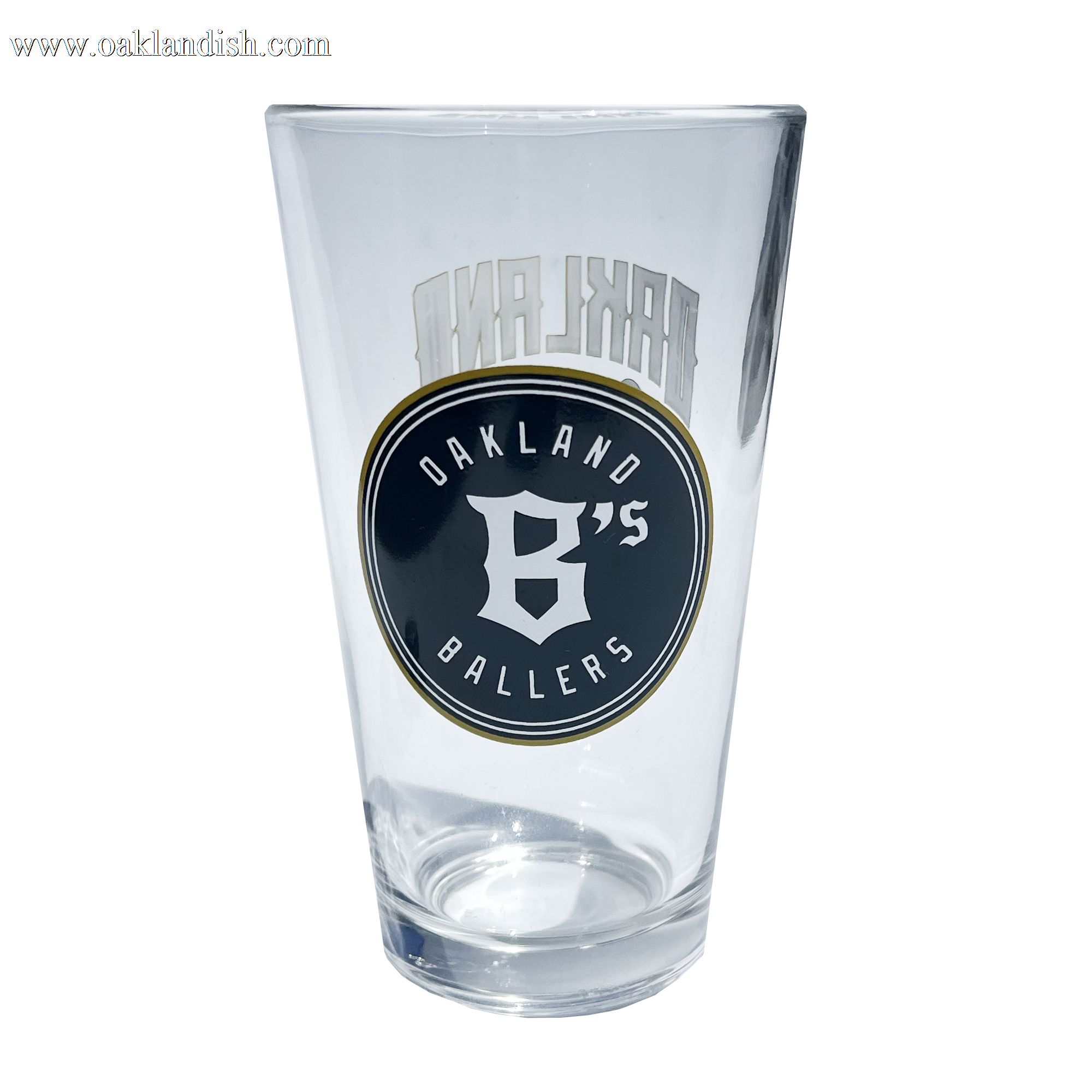 Angled image of pint glass with Oakland Ballers baseball logo in green and gold.