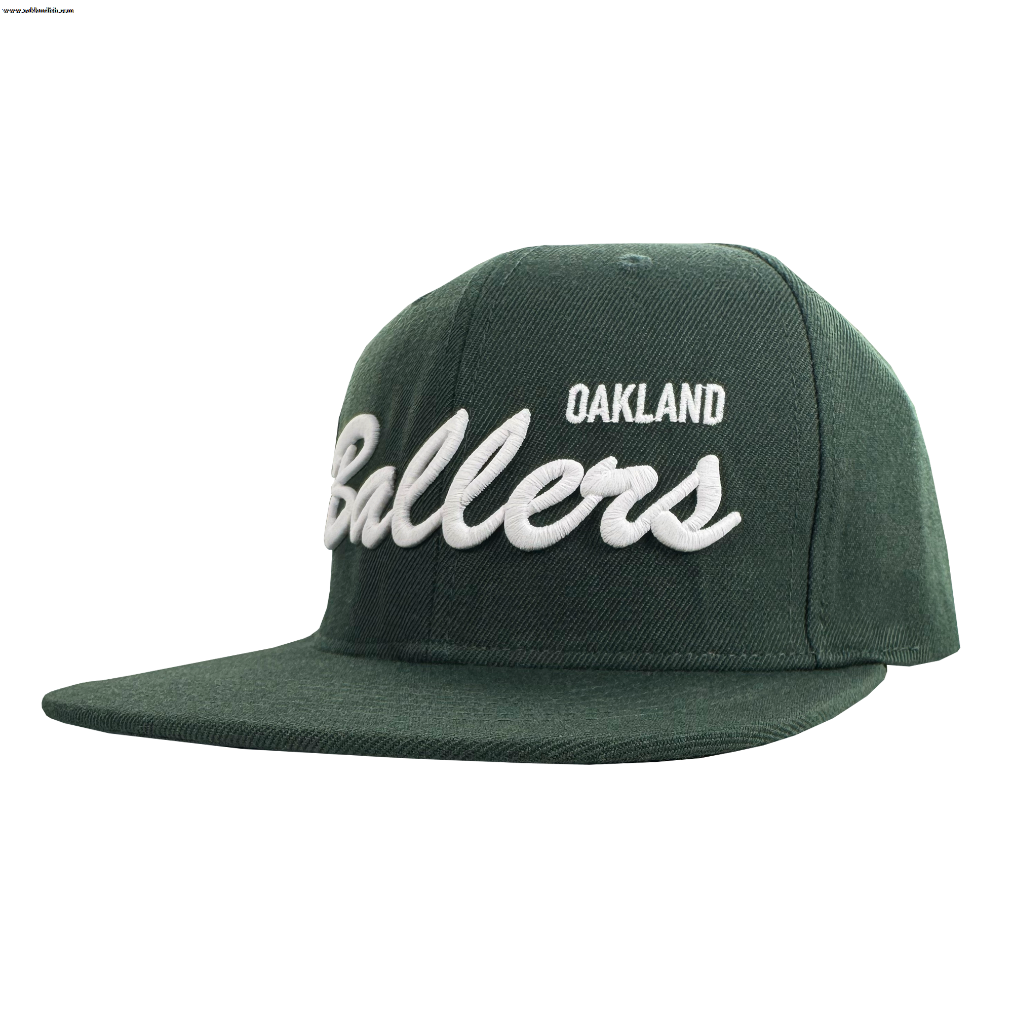 The Oakland Ballers Script Snapback is a dark green hat with "OAKLAND" in small white capitals and "Ballers" in bold cursive, featuring a flat brim and structured crown. Celebrates the Oakland Ballers baseball team. Brand: Oakland Ballers.
