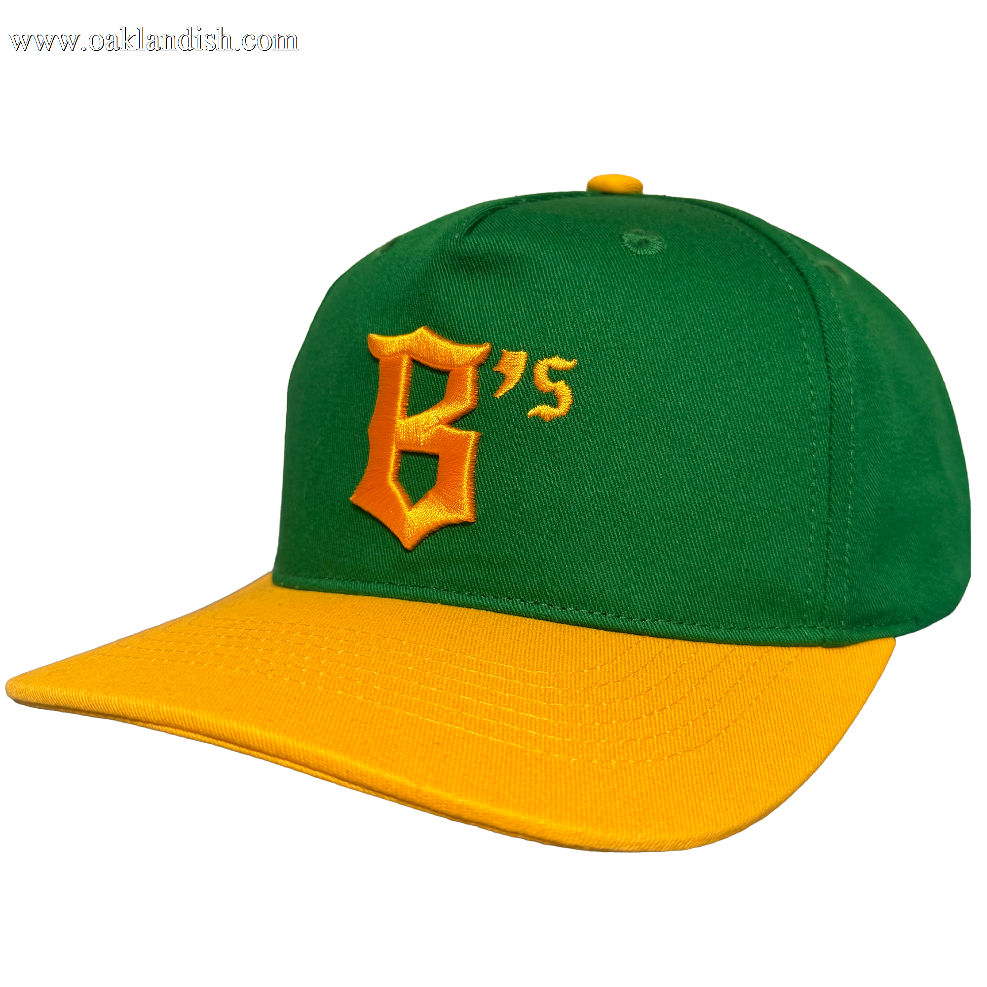 The Oakland Ballers 5 Panel Cap features a green snapback design with a yellow brim and top button, plus a large embroidered yellow "B’s" on the front. Shown against a plain white background. Brand: Oakland Ballers.