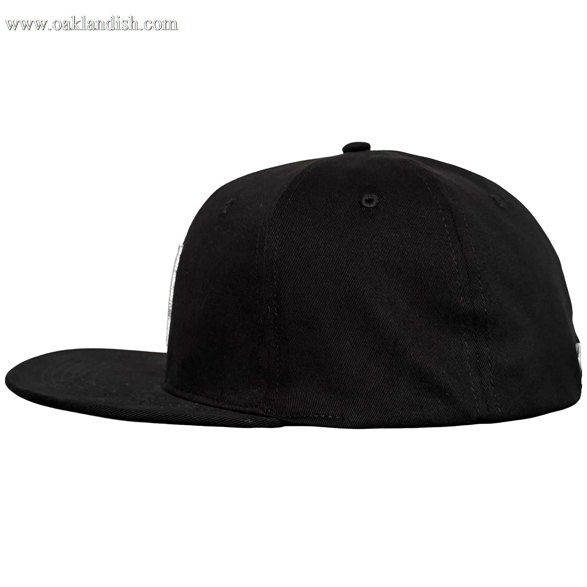 The Oakland Stand Up Hat by Oakland Ballers is a black, flat-brim baseball cap with a structured crown and small top button, shown from the left side on a plain light gray background. The cap has no visible logos or designs.