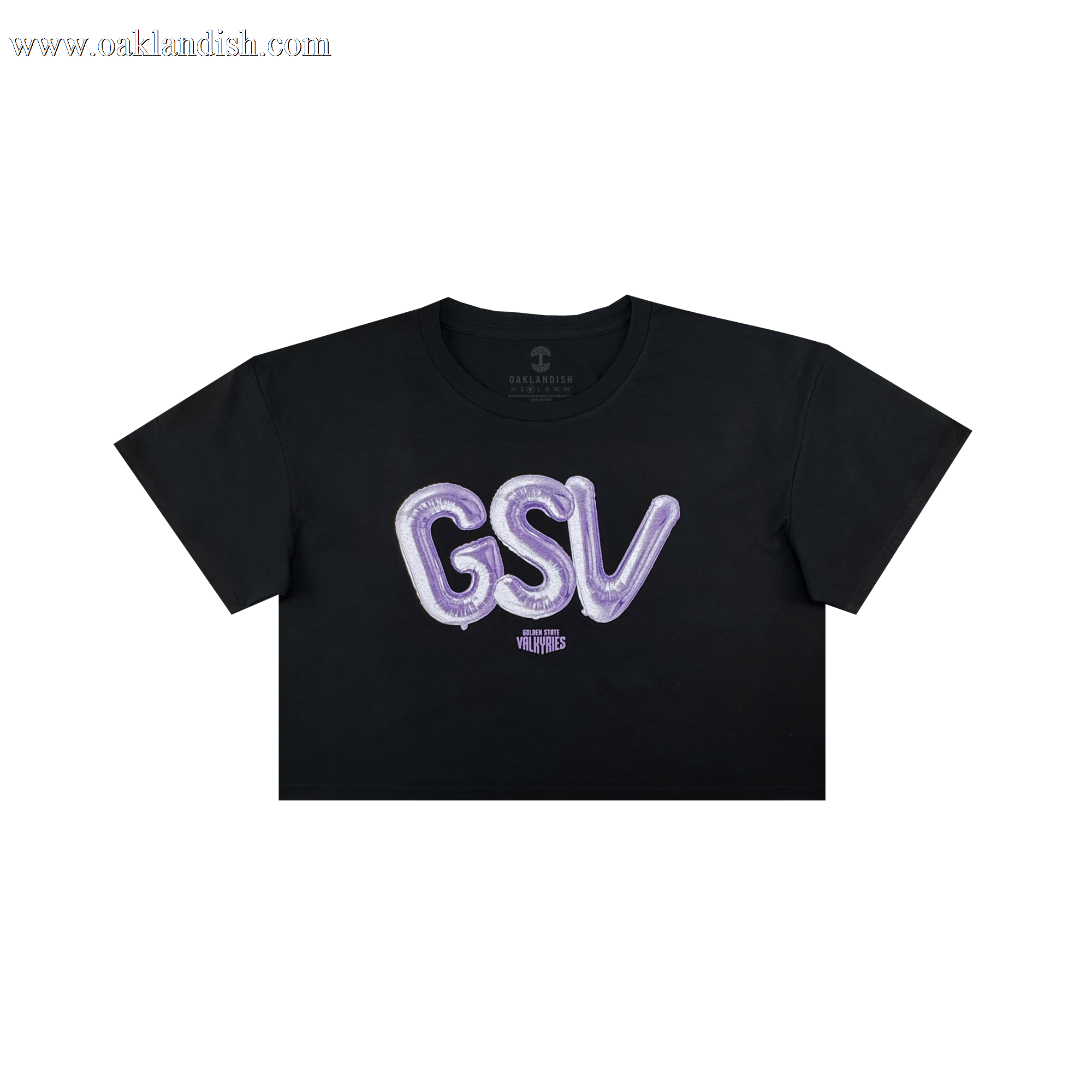 The Women’s Golden State Valkyries Balloons Crop Tee by GSV is a black cropped t-shirt with bold, shiny purple “GSV” balloon letters and a small white “VLVT STUDIOS” logo beneath, inspired by the Golden State Valkyries.