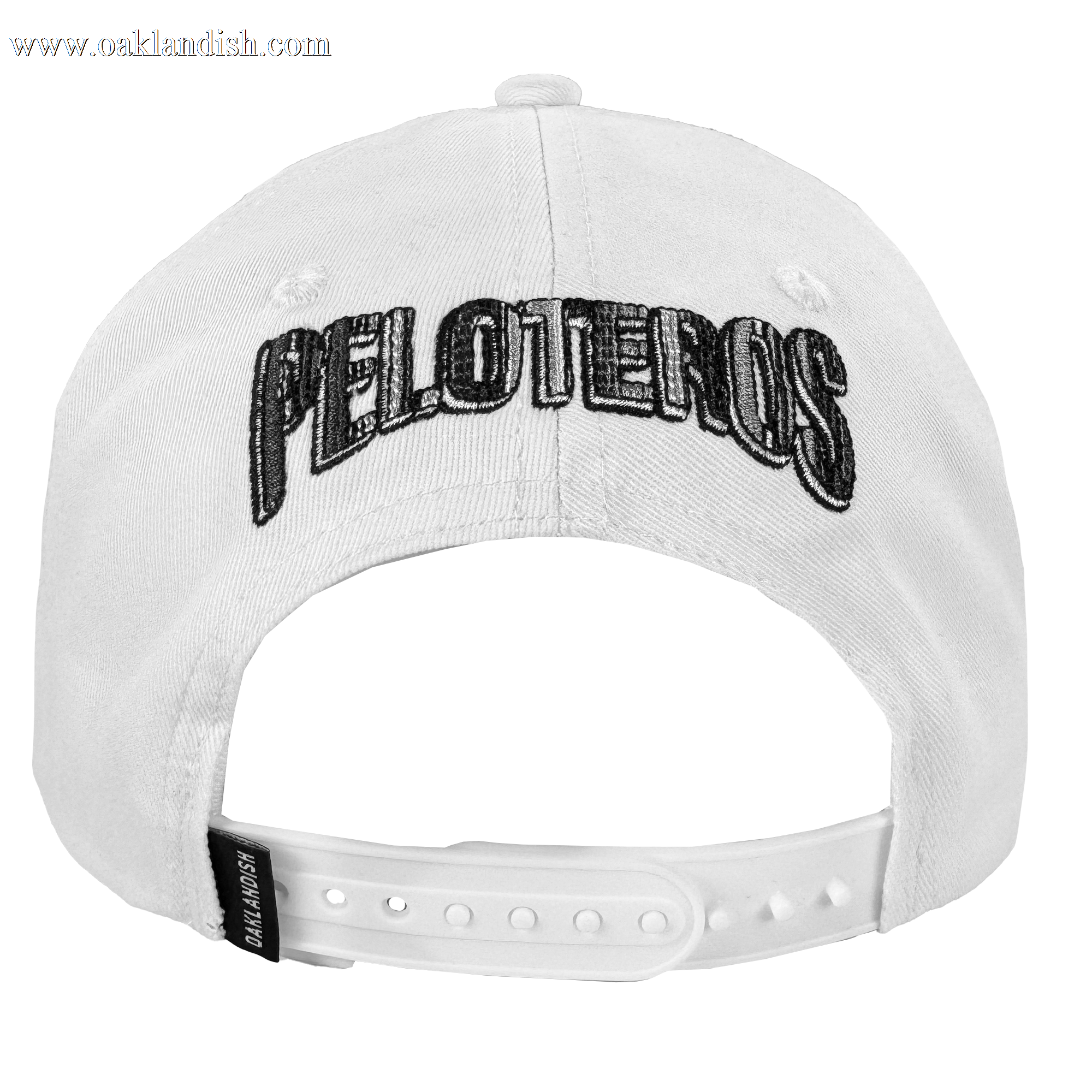 The Oakland Beisbol 5 Panel Cap by Oakland Ballers is a white snapback featuring bold black "PELOTEROS" embroidery on the back, an adjustable plastic closure, and a small black "BALLTAILORS" tag at the bottom.