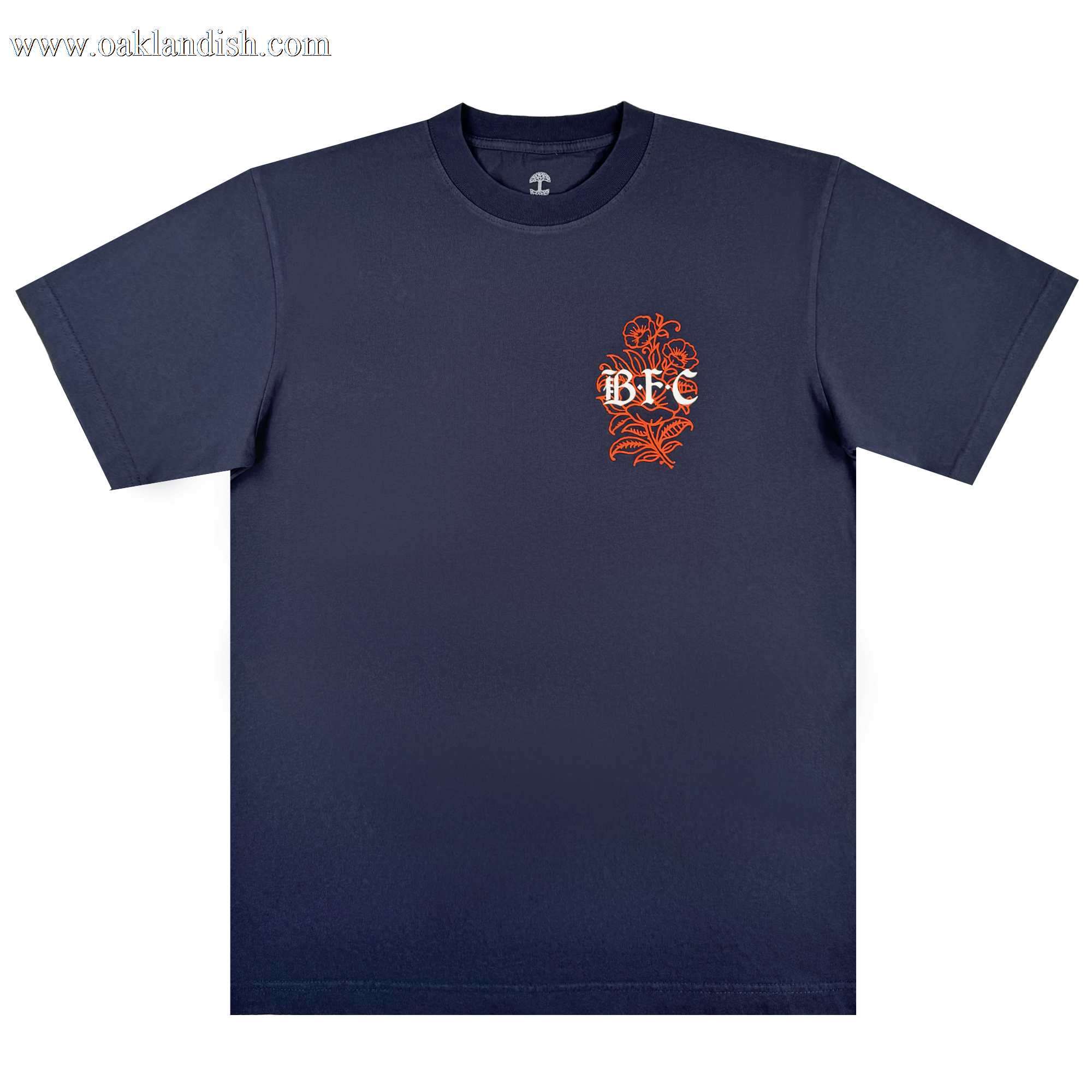 The Bay FC Flora Tee by Bay FC is a navy classic fit heavyweight cotton t-shirt featuring a small orange floral design and white "BFC" text on the left chest, laid flat on a plain white background.
