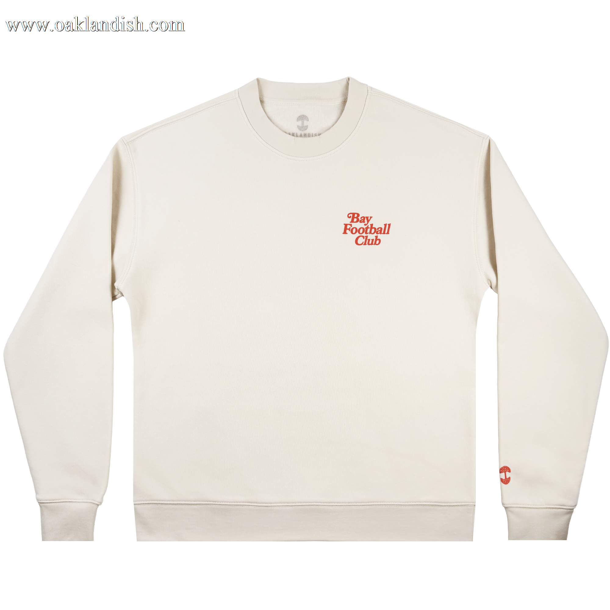 The Bay FC Jubilee Crew is a cream crewneck sweatshirt with "Bay Football Club" in small red text on the left chest and a red logo on the left sleeve cuff. Shown in men's sizing, it’s laid flat on a white background.