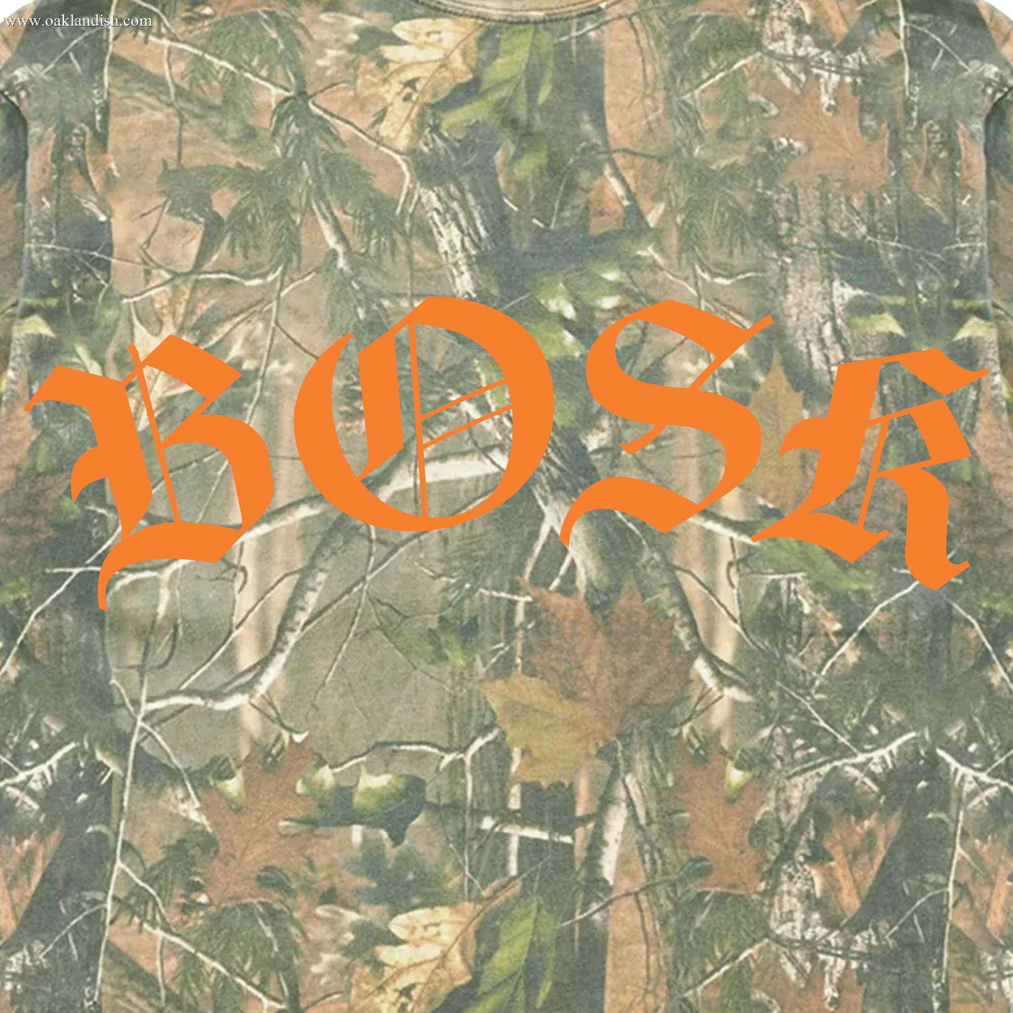 The BOSK Camo Tee by BOSK showcases an oversized fit with a tree camo design featuring green, brown, and tan leaves and branches on heavyweight cotton. The center displays bold orange "BOSK" in gothic script.
