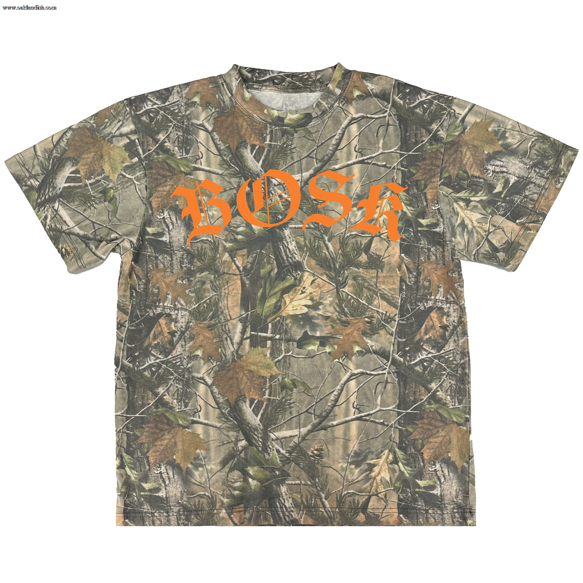 The BOSK Camo Tee by BOSK features heavyweight cotton in an oversized fit, green and brown Tree Camo branches and leaves, and bold orange gothic “BOSK” lettering across the chest.