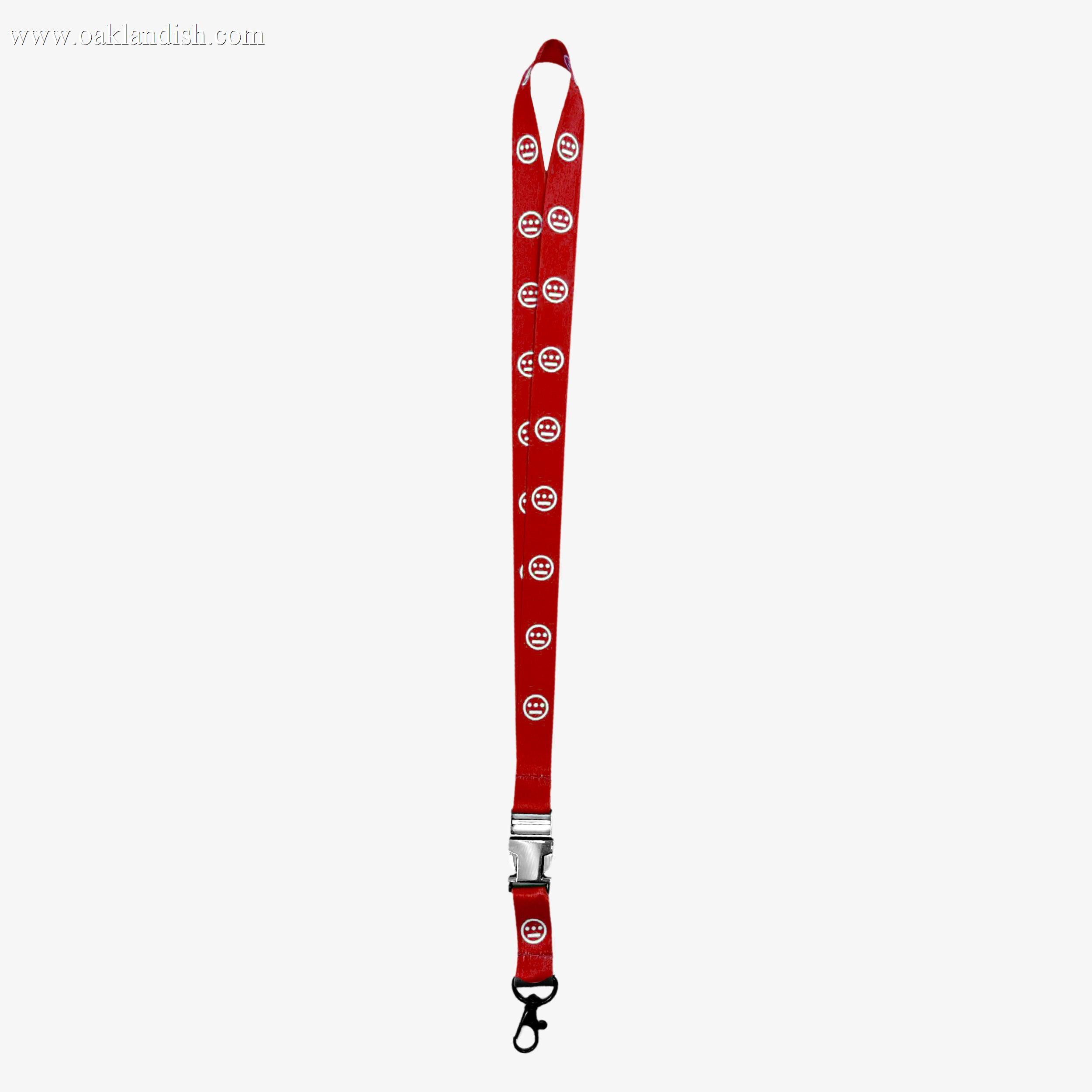 The Hieroglyphics Hiero VIP Lanyard 2.0 is a striking red lanyard adorned with white circular logos featuring a stylized "N" design, repeated along its length. It includes a black plastic clip and a metal buckle near the bottom, along with a black hook attachment at the end for holding items—perfect for achieving that VIP lanyard look.