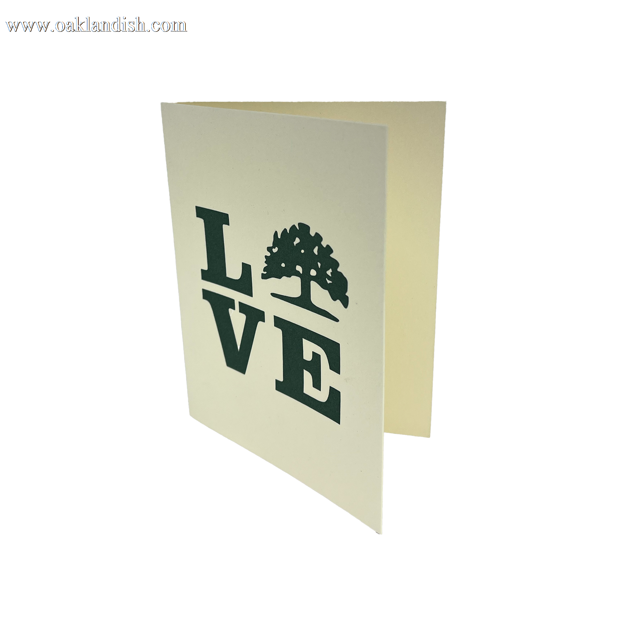 The Love Tree Card by Never Elsewhere is a vertically standing letterpress greeting card featuring the word "LOVE" on the front, with a tree silhouette replacing the "O." Made of cream-colored paper, this Oakland-inspired card is slightly open, revealing a blank inside.