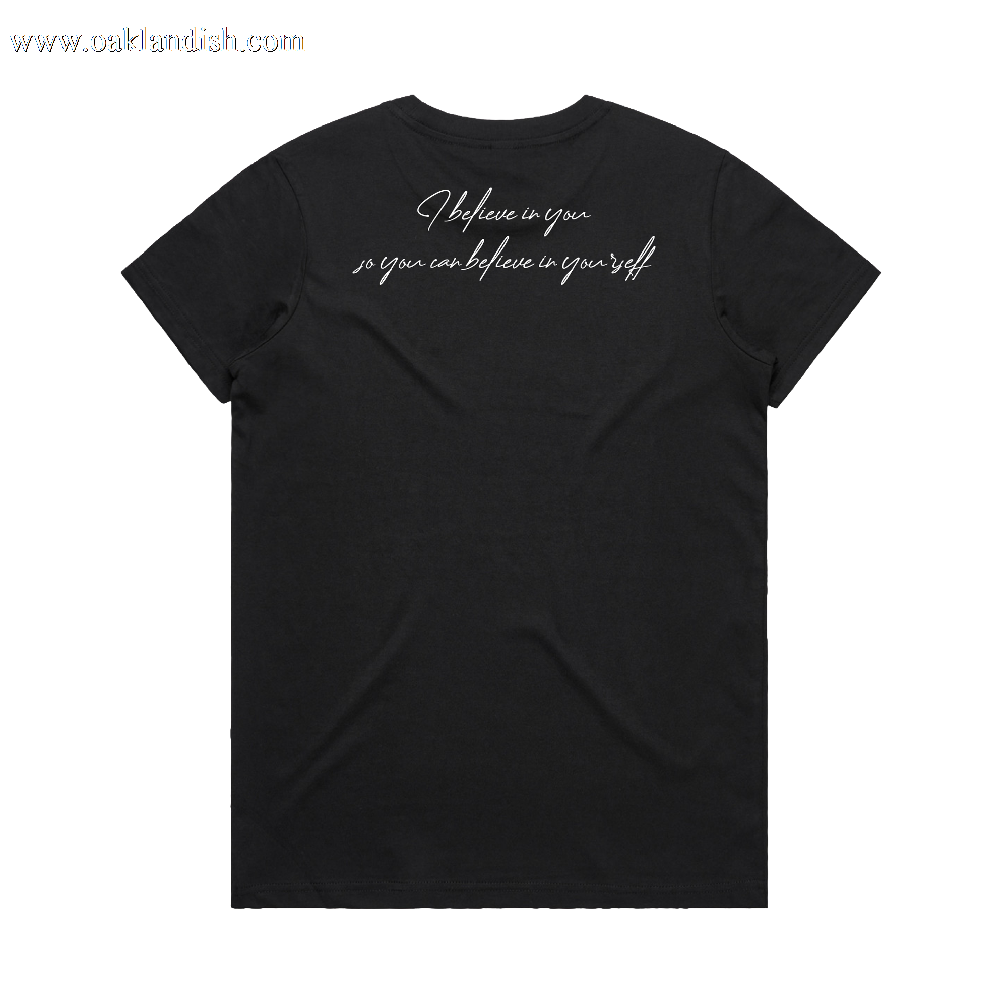 The Women's Coach Beam's Legacy Tee by Oaklandish is a black short-sleeve t-shirt laid flat, back facing up, featuring white cursive text near the upper back: "I believe in you, so you can believe in yourself." Inspired by Coach John Beam.