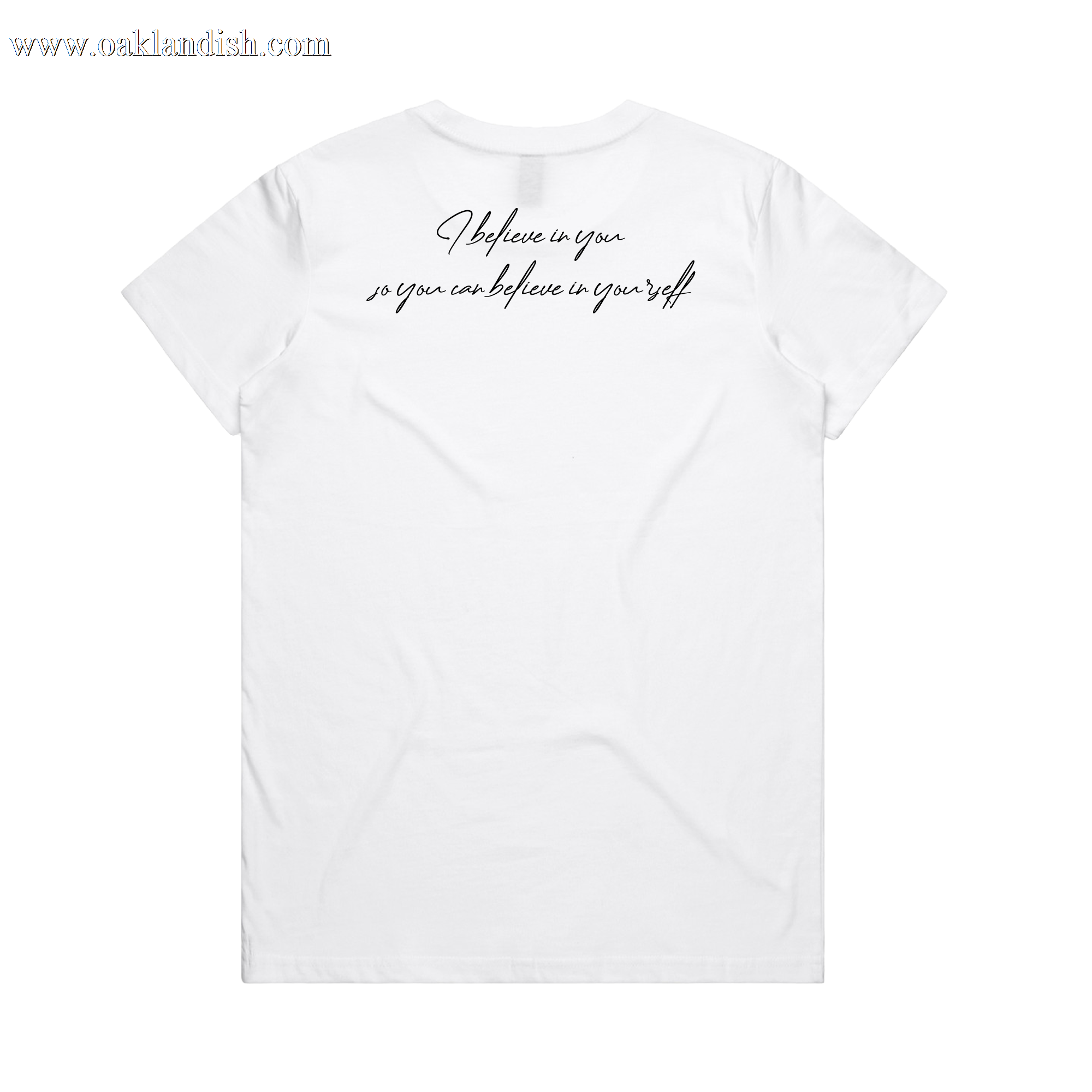 The Women's Coach Beam's Legacy Tee by Oaklandish is a plain white short-sleeve shirt with "I believe in you so you can believe in yourself." in black cursive on the back, inspired by Coach John Beam’s dedication to Oakland youth. Shown on a solid white background.