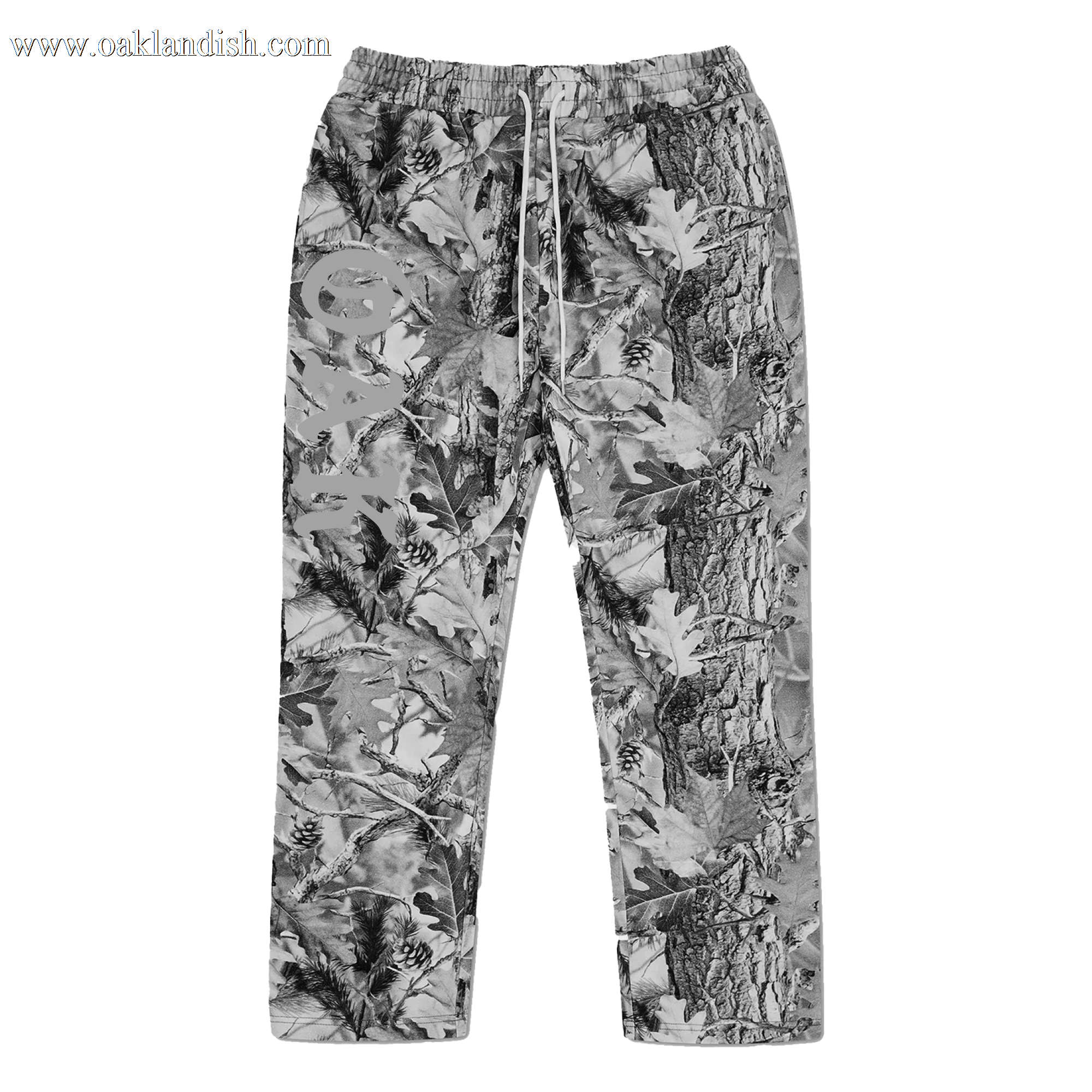 The Oaklandish Cork Pant is a loose-fitting, open-leg pant with an elastic waistband and drawstring, made from 100% cotton in Grey Wood Camo and finished with a large light graphic and stylized text on the left thigh.