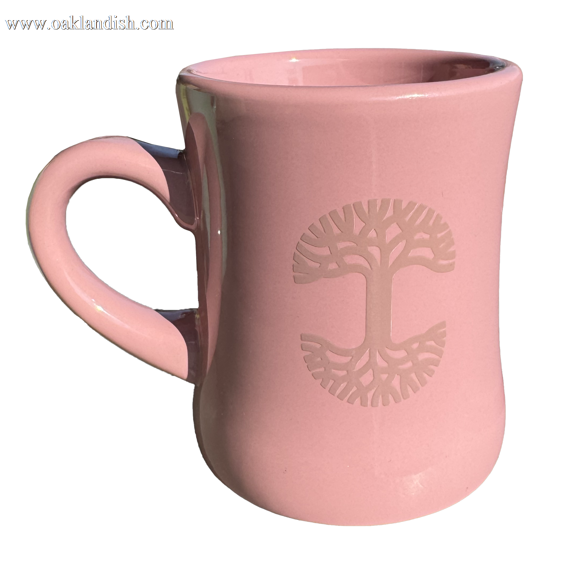 The Oaklandish Diner Mug, crafted by the brand Oaklandish, is a chic piece of ceramic drinkware featuring a pink color with a flared rim and a left-curved handle. Its embossed design highlights a stylized tree with symmetrical branches and roots at the center, while its glossy finish elegantly reflects light.