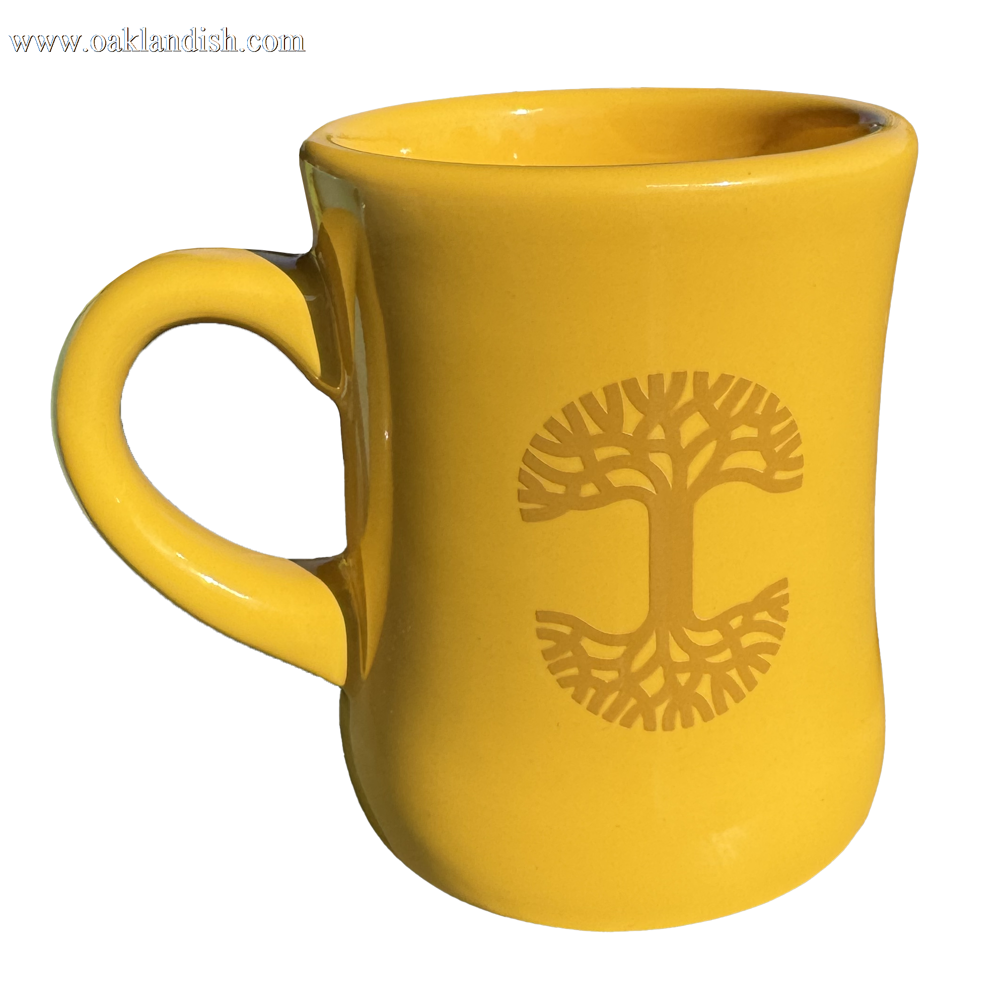 This Oaklandish Diner Mug, a striking piece from the renowned brand Oaklandish, showcases a smooth, curvy design with a left-sided handle. The yellow ceramic mug is beautifully adorned with a darker yellow stylized tree of life symbol, where the branches and roots reflect each other gracefully.