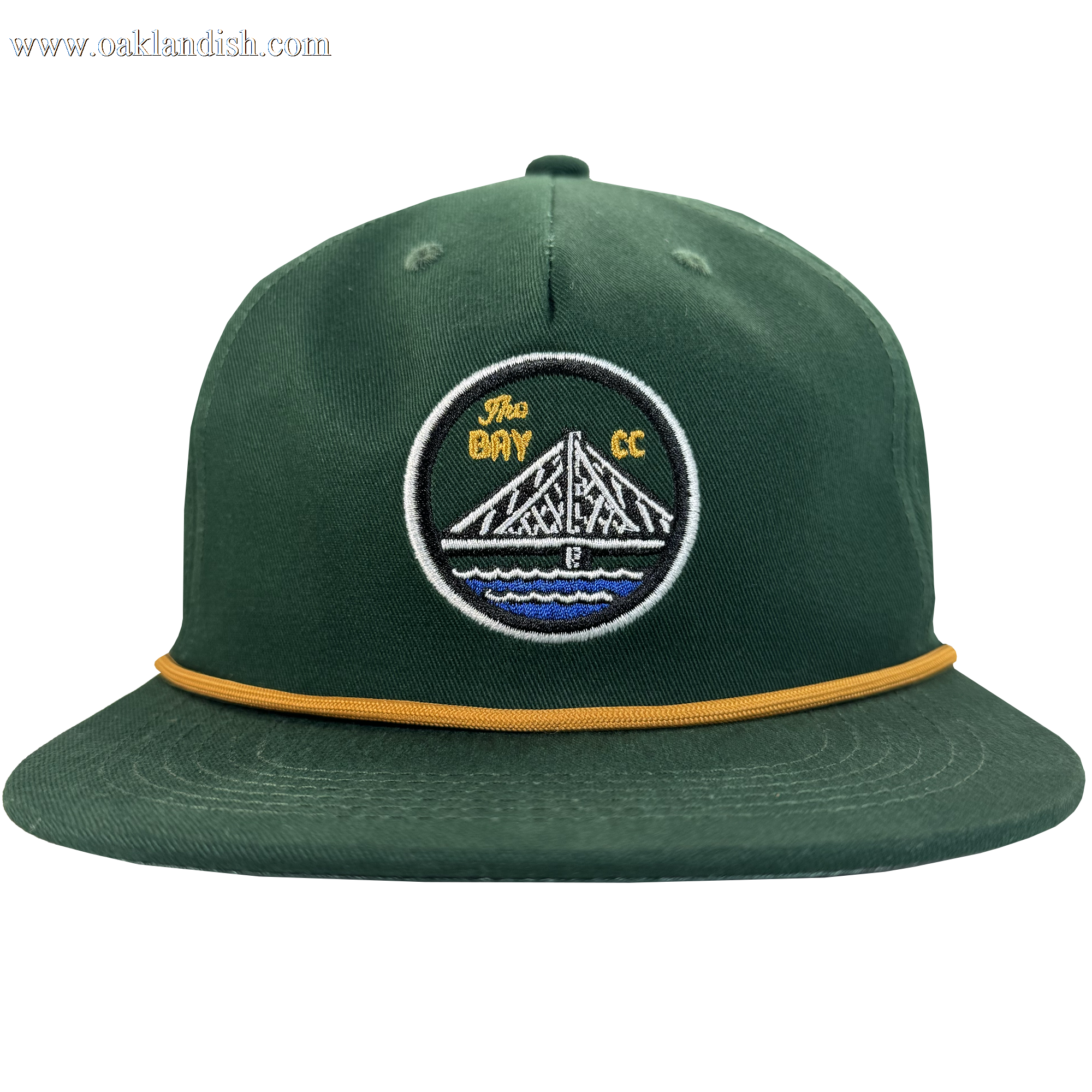 The Bay Area 5 Panel by DOC from Oaklandish is a green hat with a structured crown, gold rope detail, and a patch showing a white bridge over blue water with "The Bay CC" in yellow on black.