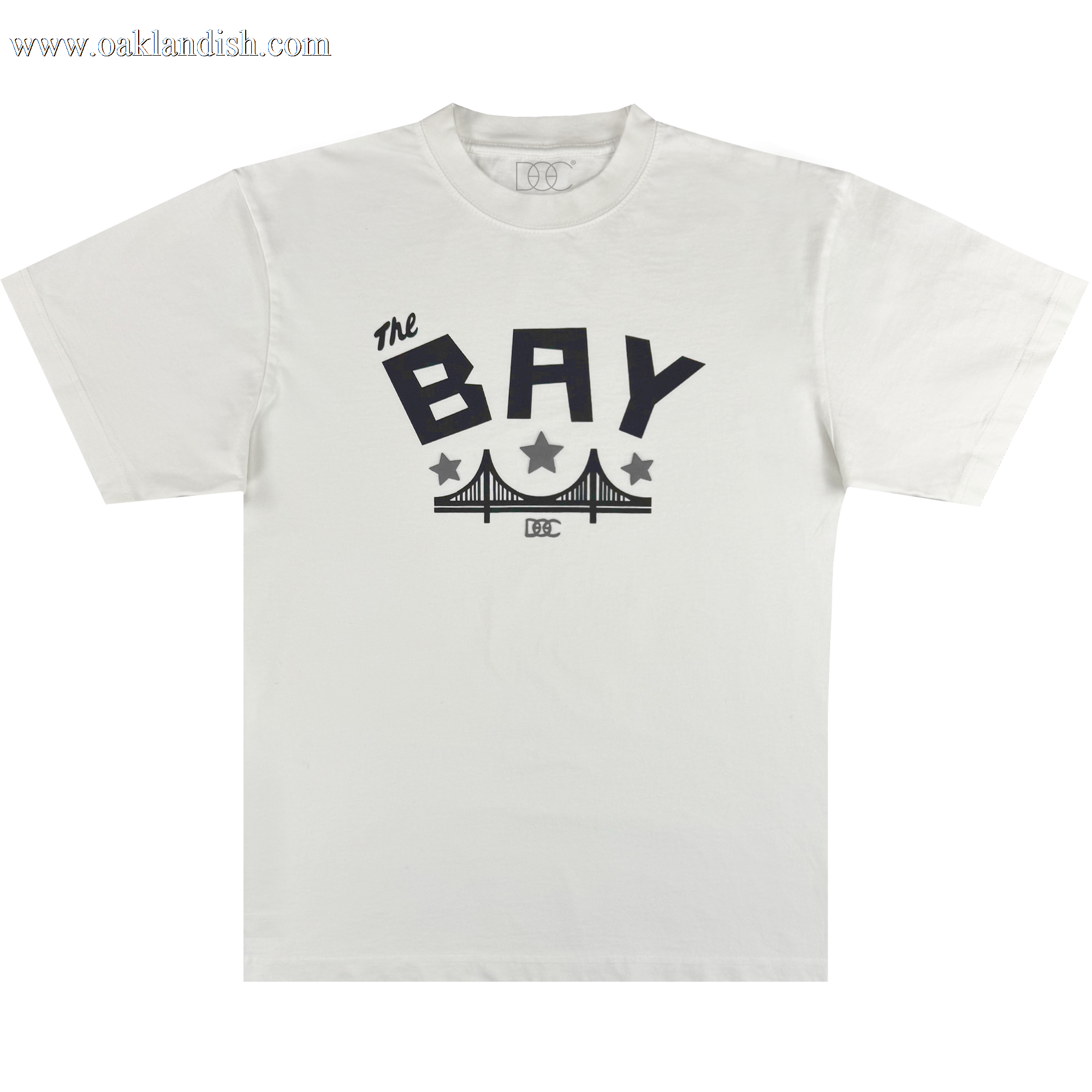 The Bay Bridge Tee By DOC V2 from Oaklandish features a classic fit in heavyweight cotton, with bold black "The BAY" text above a stylized bridge, two black stars, and a small rectangular logo below.