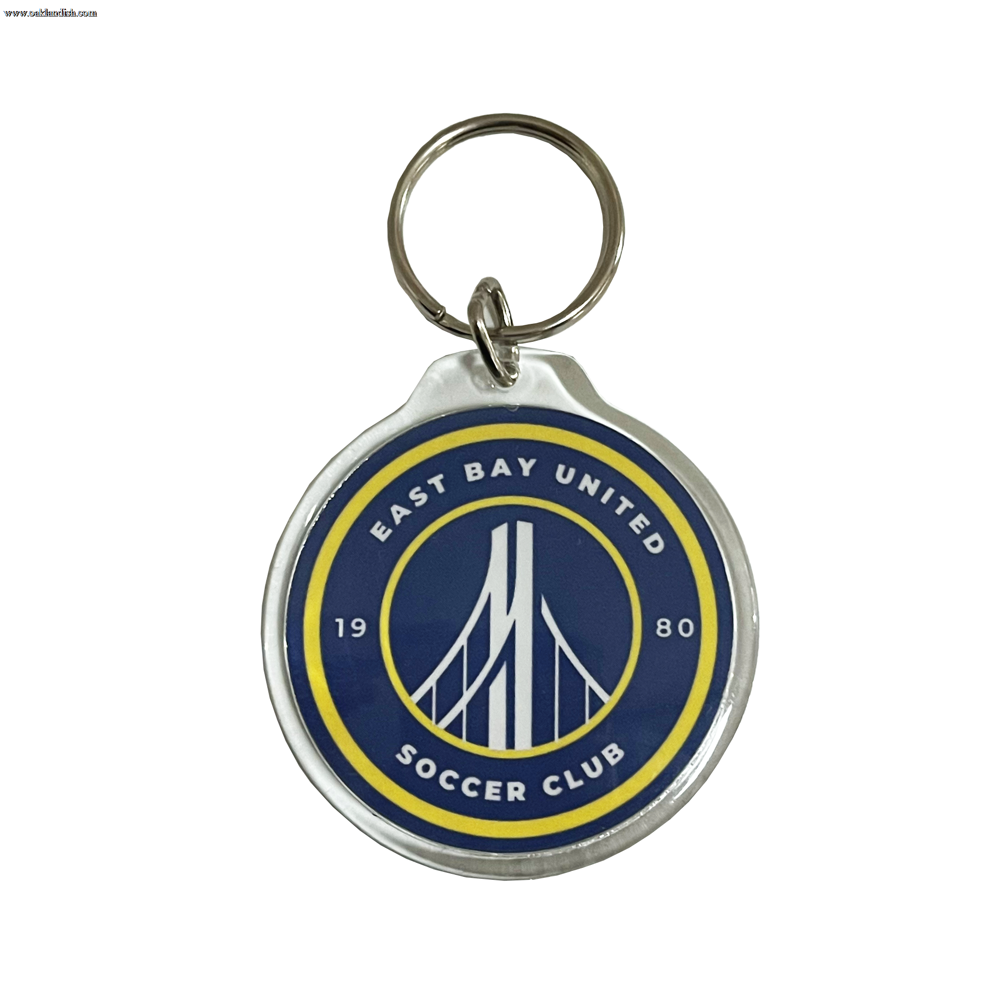 Metal key chain with blue and yellow logo of the the East Bay United Soccer Club,.