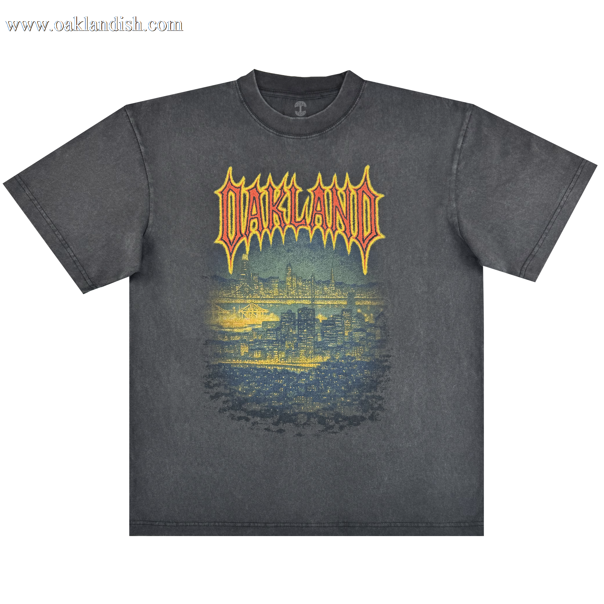 The Oaklandish Ember Tee is a faded black classic fit, 100% cotton shirt featuring "OAKLAND" in bold yellow and red above a detailed blue Oakland skyline graphic on a glowing background for a cool nighttime vibe.