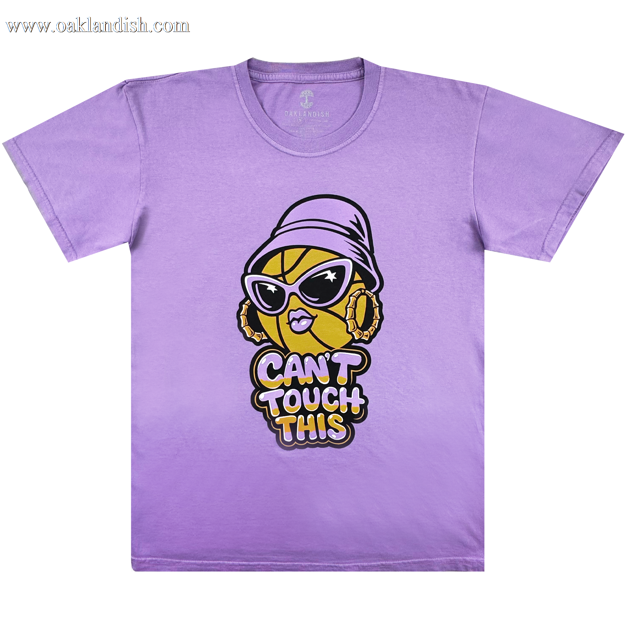 The Can't Touch This Tee by GSV features a lavender, 100% cotton classic fit with a cartoon basketball in sunglasses, hoop earrings, and a purple bucket hat. Centered below is bold yellow, white, and black "CAN'T TOUCH THIS" text.