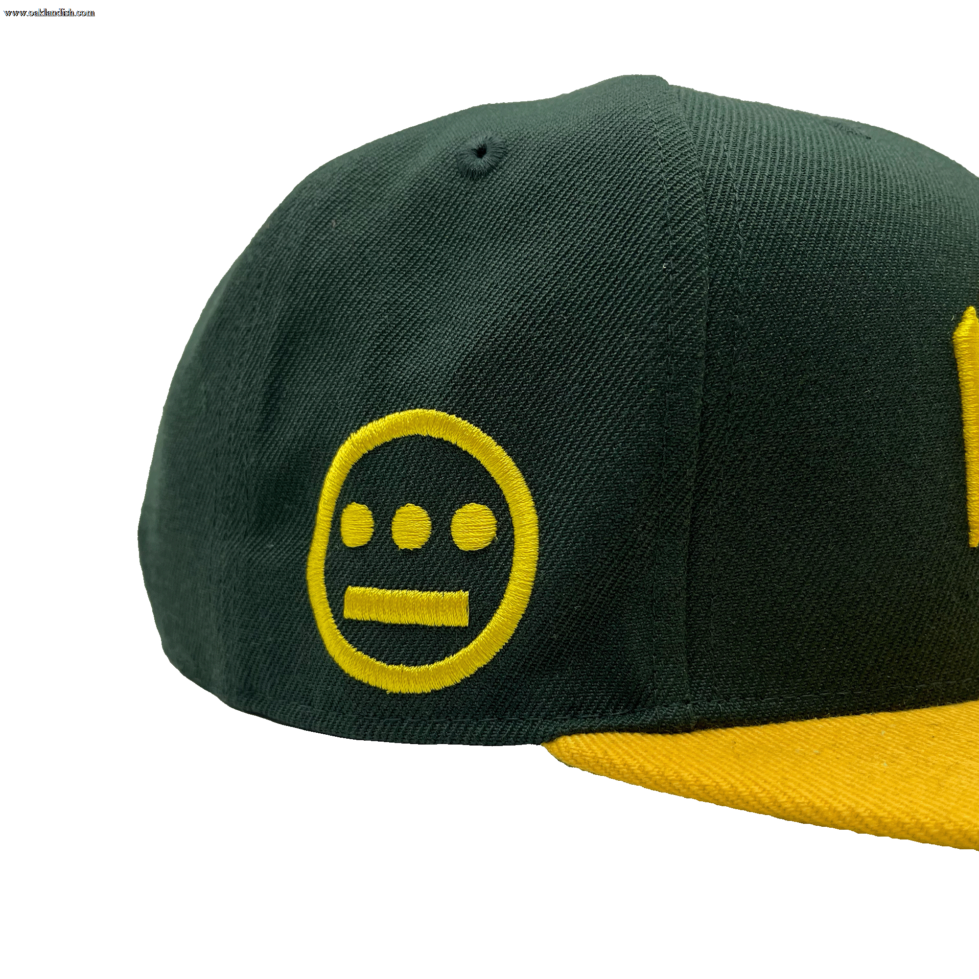 Side view of HIERO logo on the side of a green snapback cap with yellow flat billed visor.