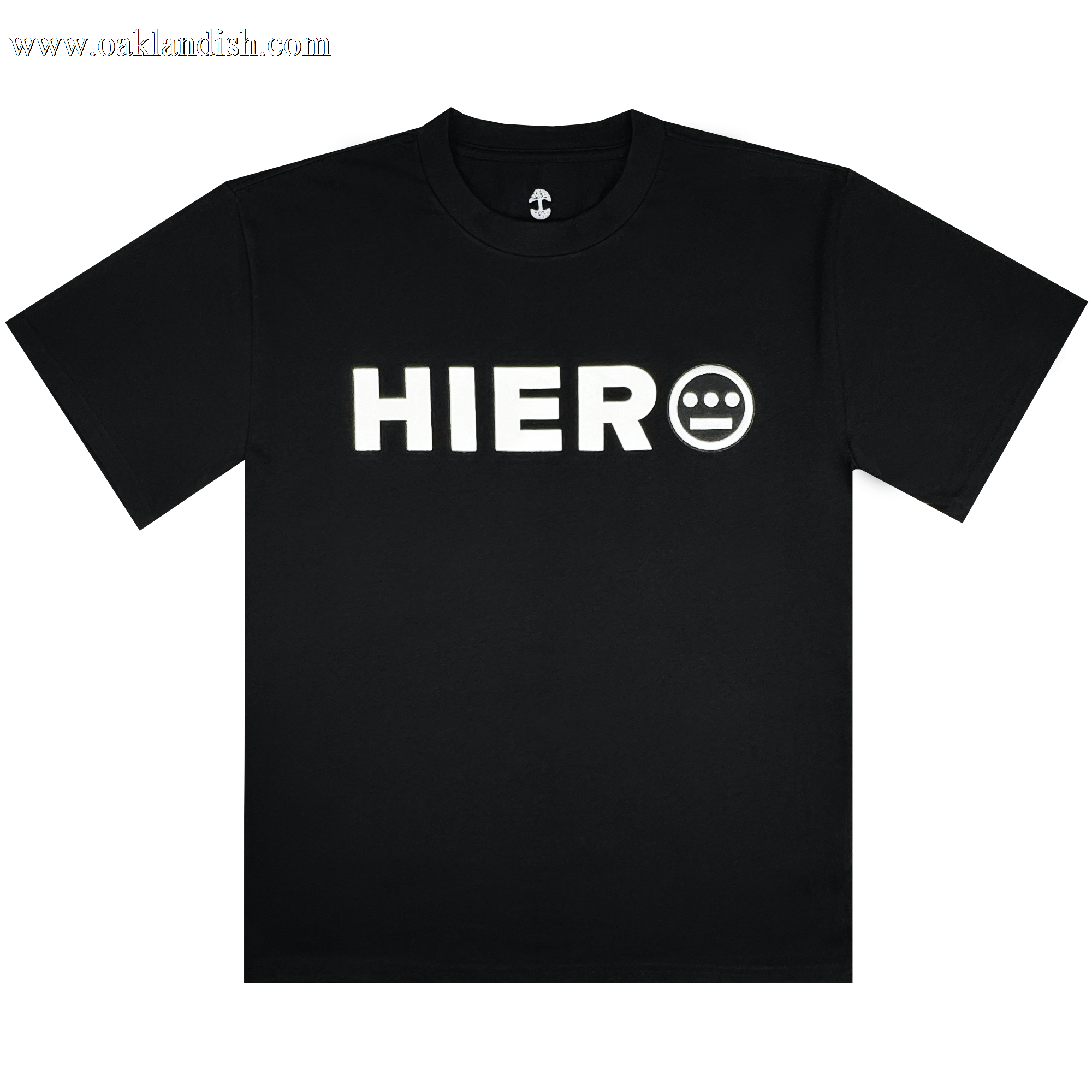 The Hiero Bold Heavy Tee by Hieroglyphics is a black T-shirt with "HIERO" in bold white letters on the chest, inspired by hip-hop culture. It features a face-like white circle with three lines and two dots, round neckline, and short sleeves against a white background.