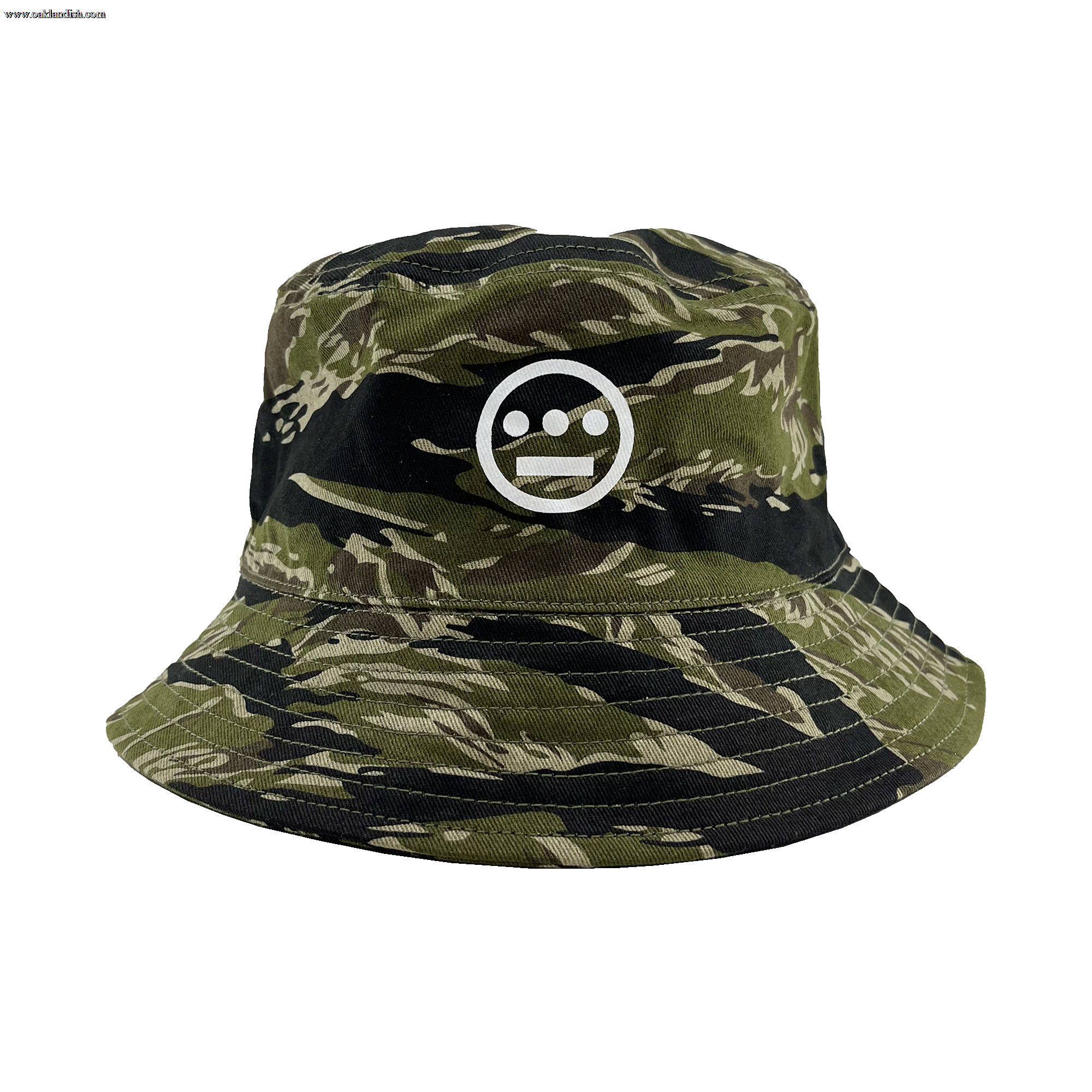 Introducing the Hieroglyphics Hiero Reversible Camo Bucket: A stylish bucket hat featuring a green and black tiger camo pattern, adorned with a white embroidered hieroglyphic symbol on the front. The unique symbol showcases a horizontal line with three dots above it, encased within a circle. This versatile hat boasts a wide, stitched brim and offers a relaxed, casual fit perfect for any occasion.