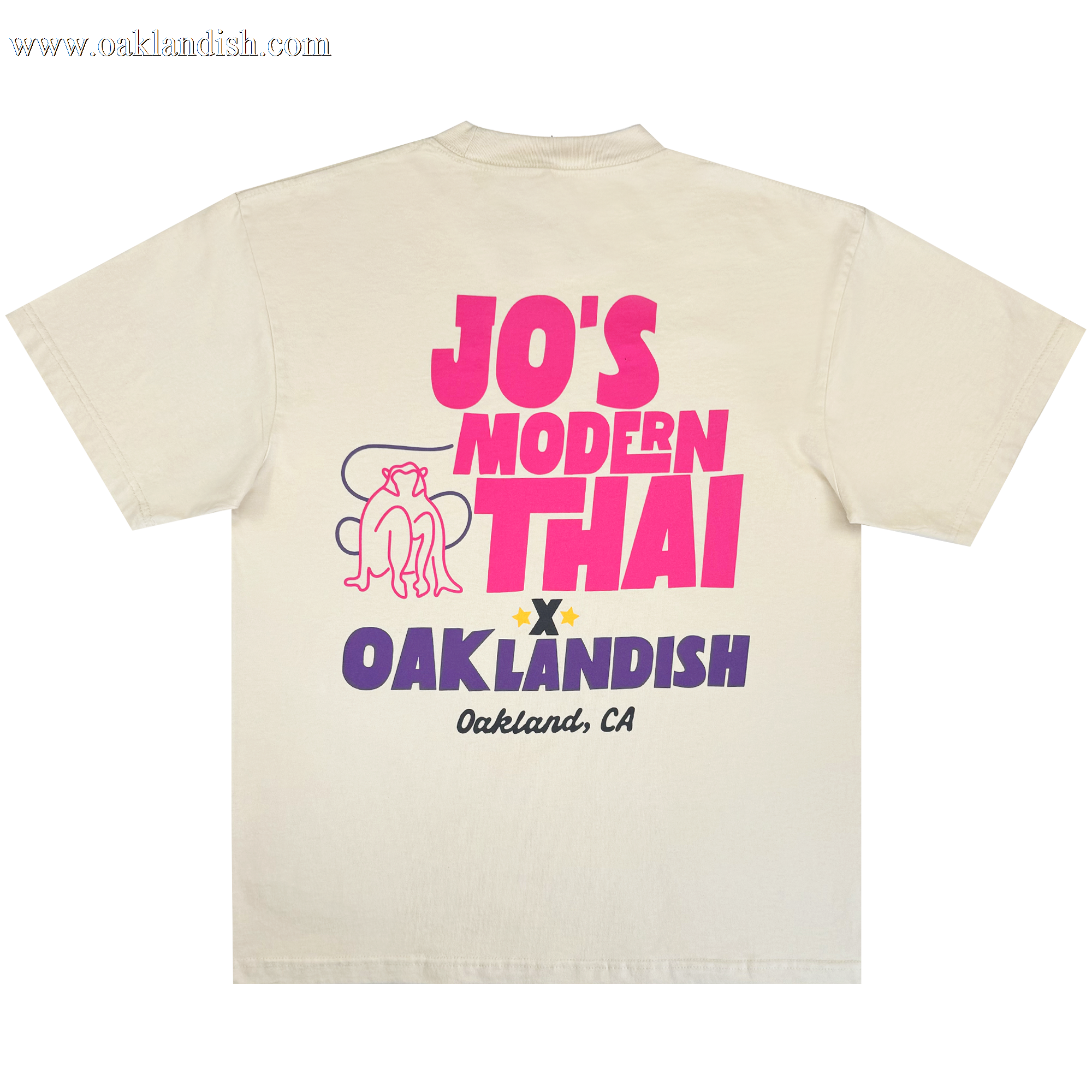 The Jo's Modern Thai X Oaklandish Tee by Oaklandish is a cream heavy-weight t-shirt showcasing bold “JO’S MODERN THAI” text, a reclining dog graphic, and “OAKLANDISH Oakland, CA” on the back—a special collaboration piece.