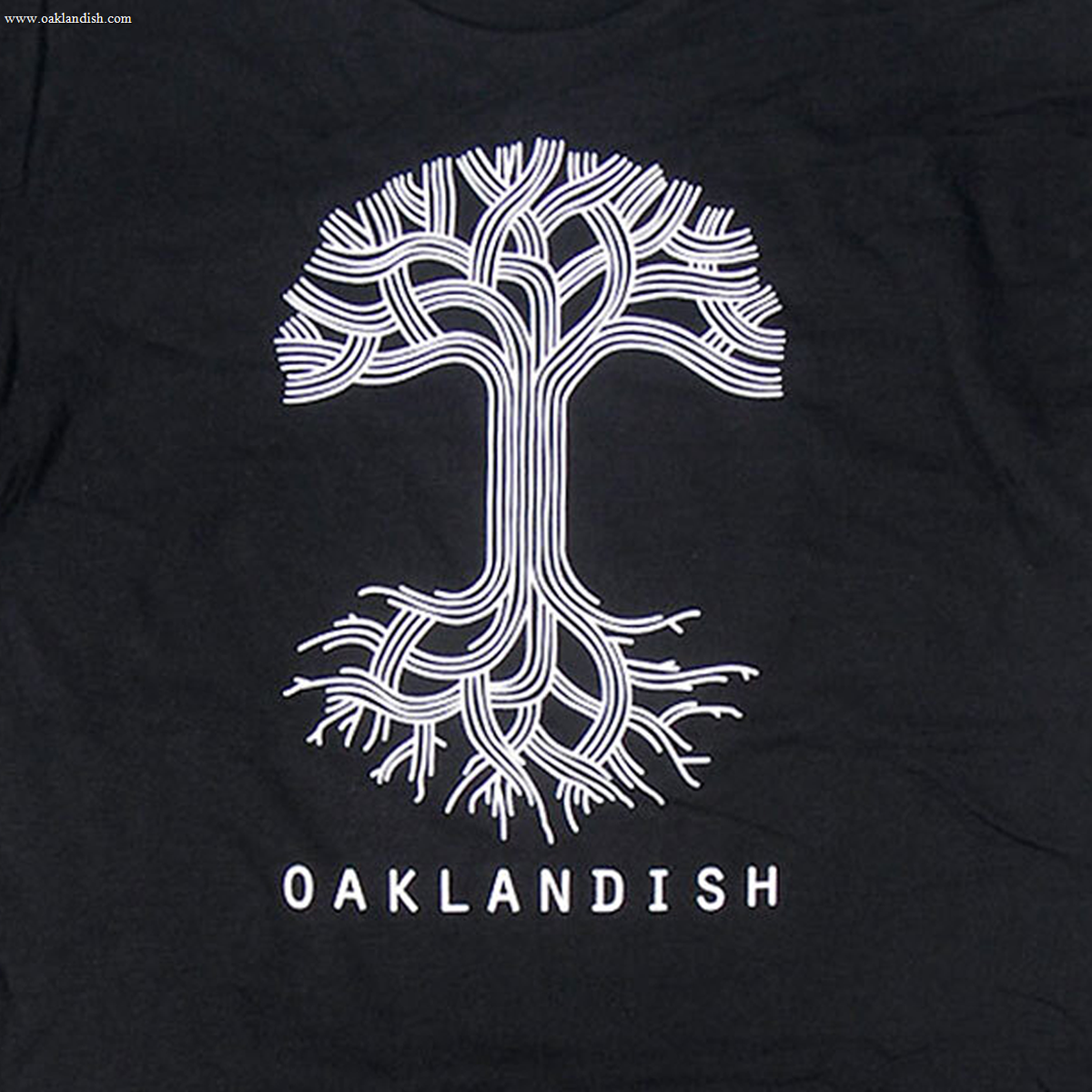 Close-up of large white Oaklandish tree logo and wordmark on the front chest of a black t-shirt.