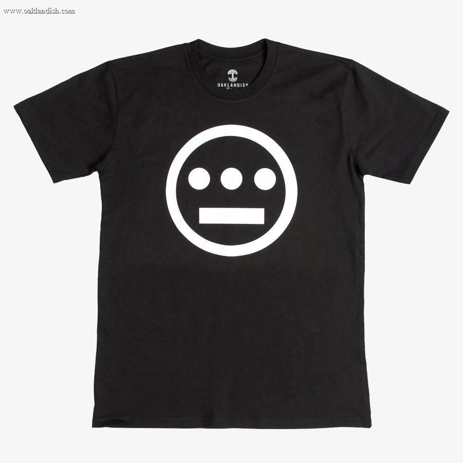 The Hiero Classic Logo Tee by Hieroglyphics is a black, classic fit T-shirt showcasing a simple, bold graphic on the front: a white circle with a horizontal line and three dots beneath it, evoking the iconic Hieroglyphics design. Featuring a crew neckline and short sleeves, this tee is displayed against a plain white background and is ideal for any hip-hop crew.