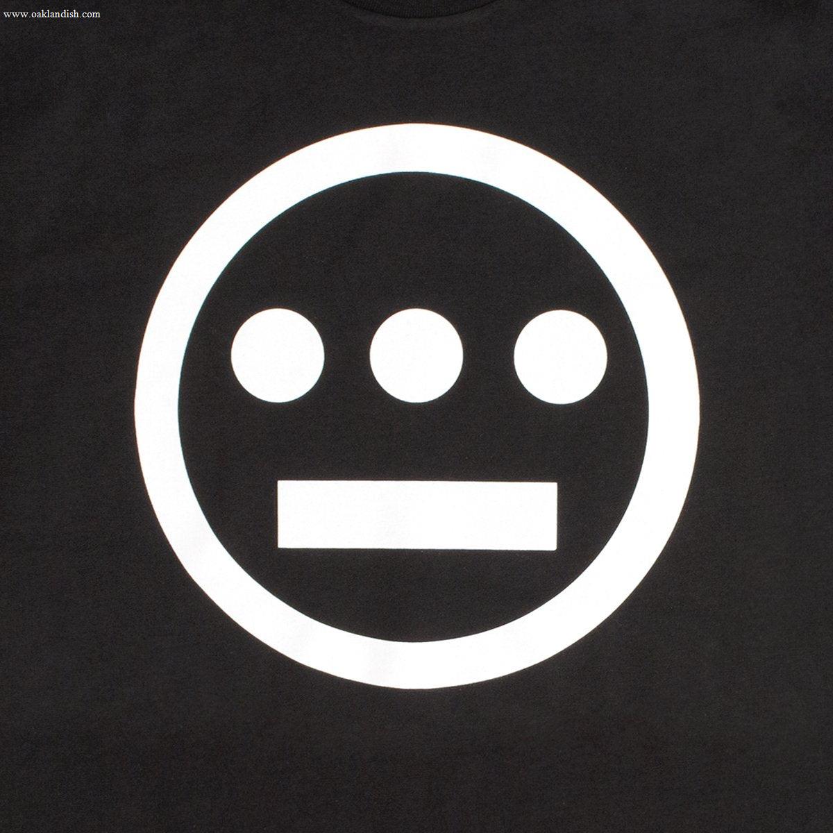 The Hiero Classic Logo Tee by Hieroglyphics showcases a black background featuring a simple white design with a circle encasing three horizontal dots positioned evenly across the top and a single horizontal line below them, reminiscent of ancient hieroglyphics.