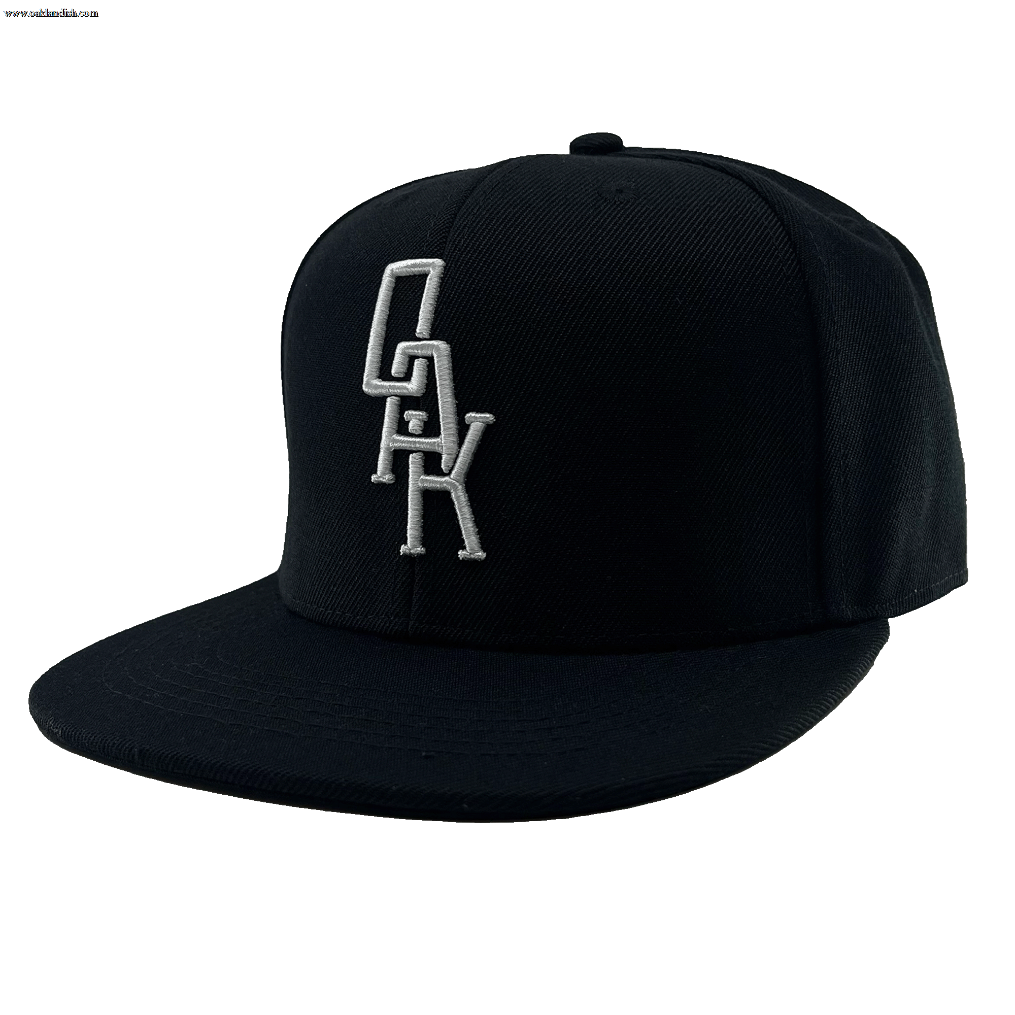 Angled side view of a black hat with a black bill and white embroidered OAK logo on the front crown.