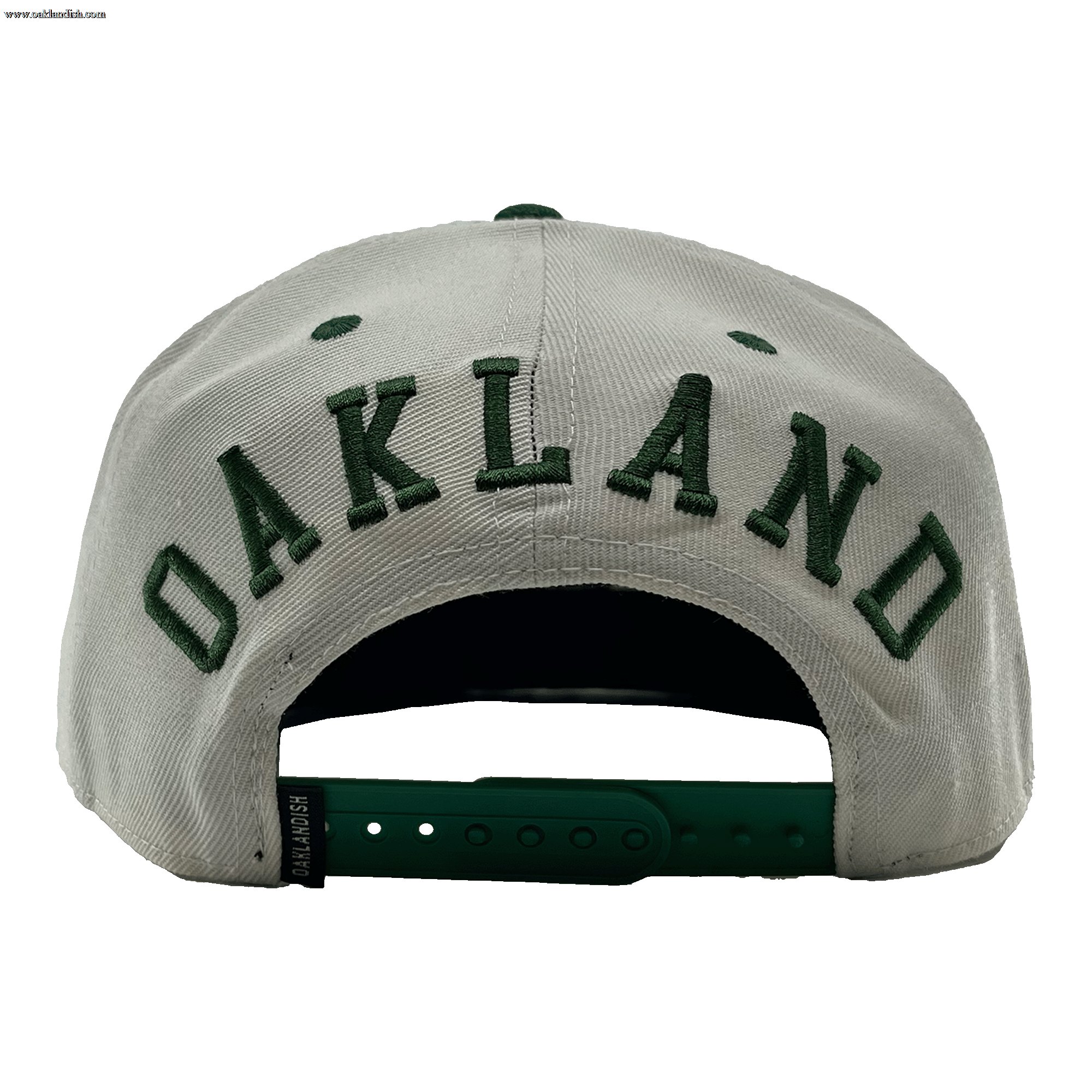 Back view of a white hat with a green adjustable snapback closure, large green embroidered OAKLANDISH wordmark, and small Oaklandish tag.