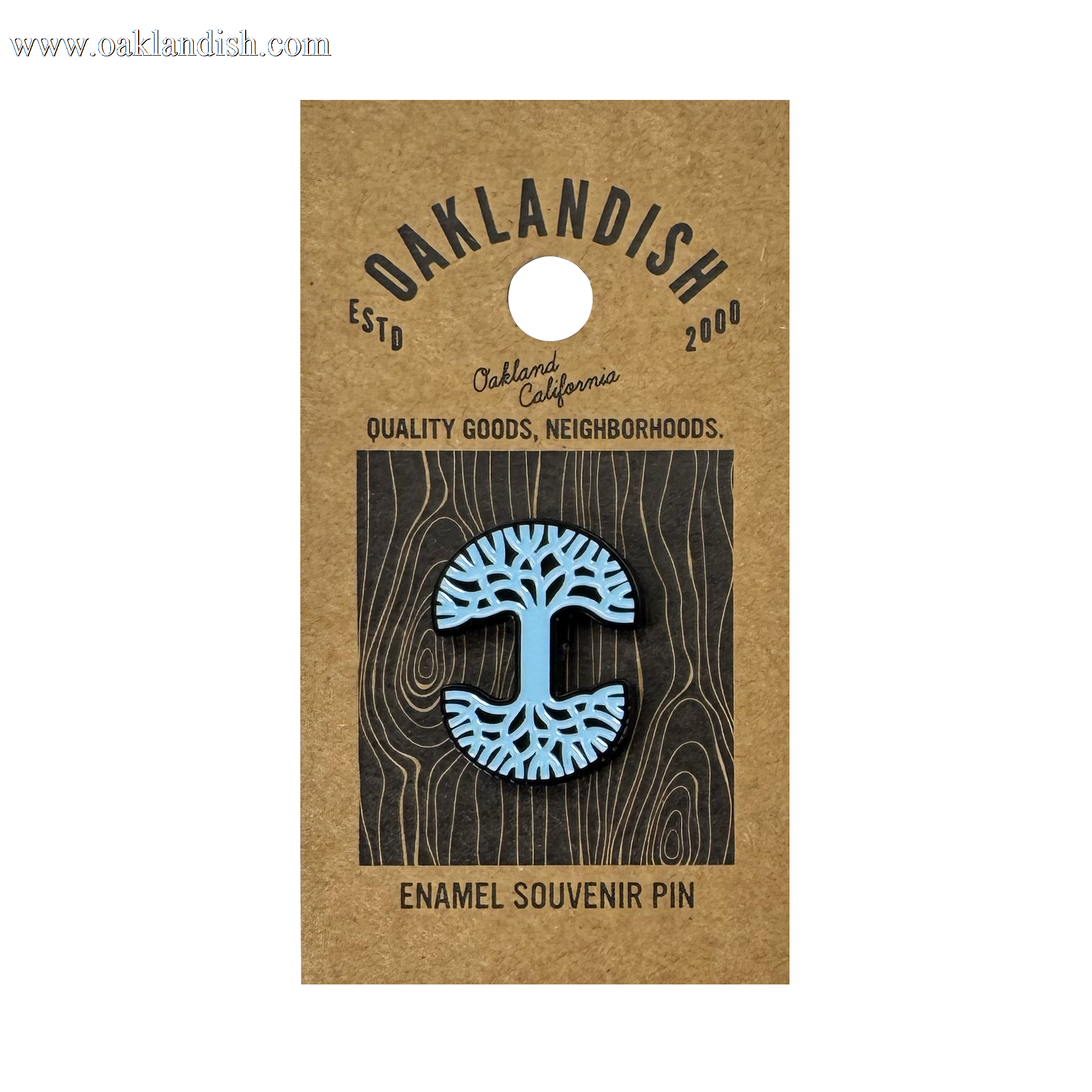 The Oaklandish Logo Enamel Pin features a blue stylized tree design and comes on a brown card reading “Oaklandish—Est’d 2000—Oakland California—Quality Goods, Neighborhoods.—Enamel Souvenir Pin.” A standout accessory.