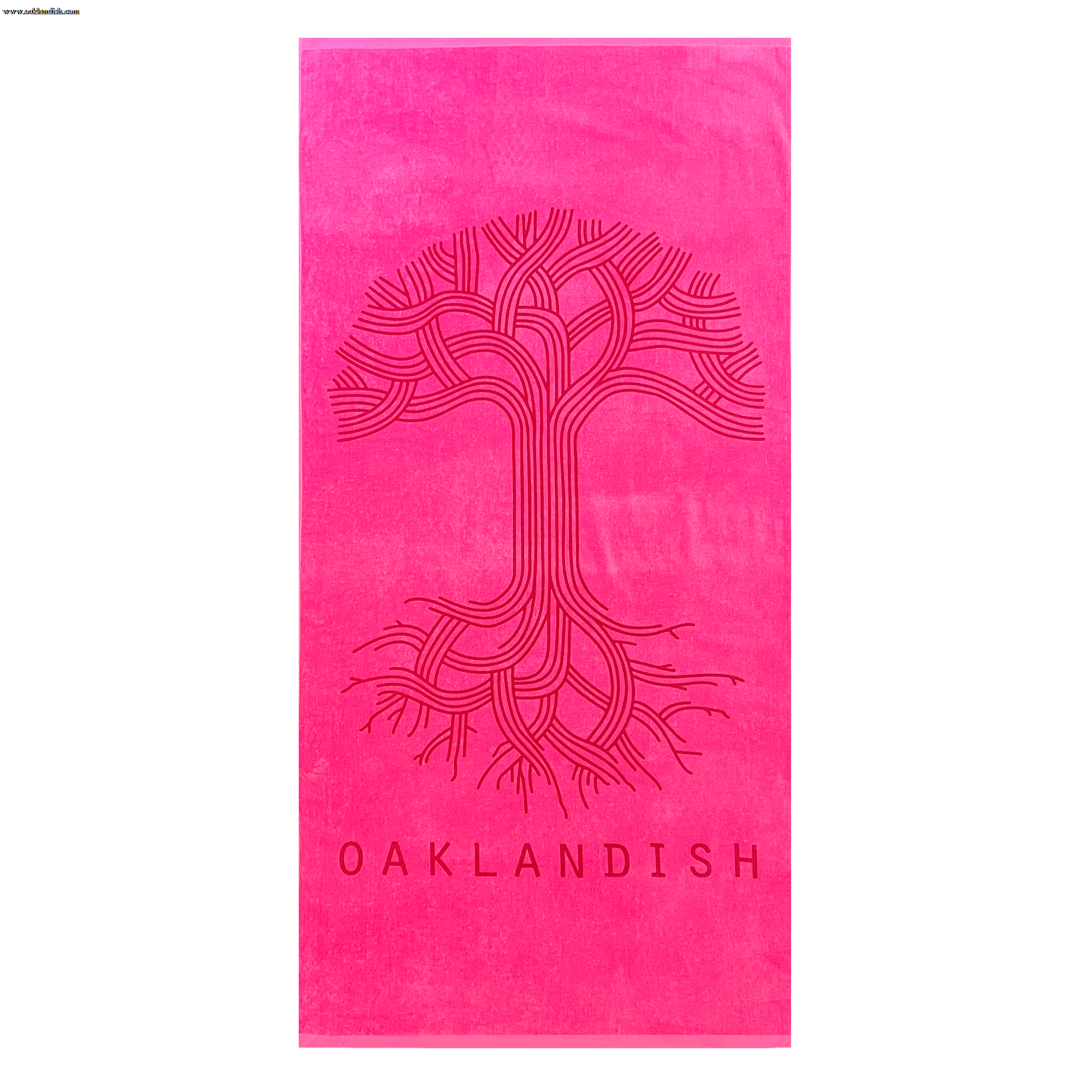 The Classic Logo Beach Towel by Oaklandish is a vibrant, oversized bright pink towel made from 100% ringspun cotton. It features an intricate, stylized tree design with intertwining branches and roots in the center. Below the tree, "OAKLANDISH" is printed in bold font, adding to its luxury and eye-catching appearance.